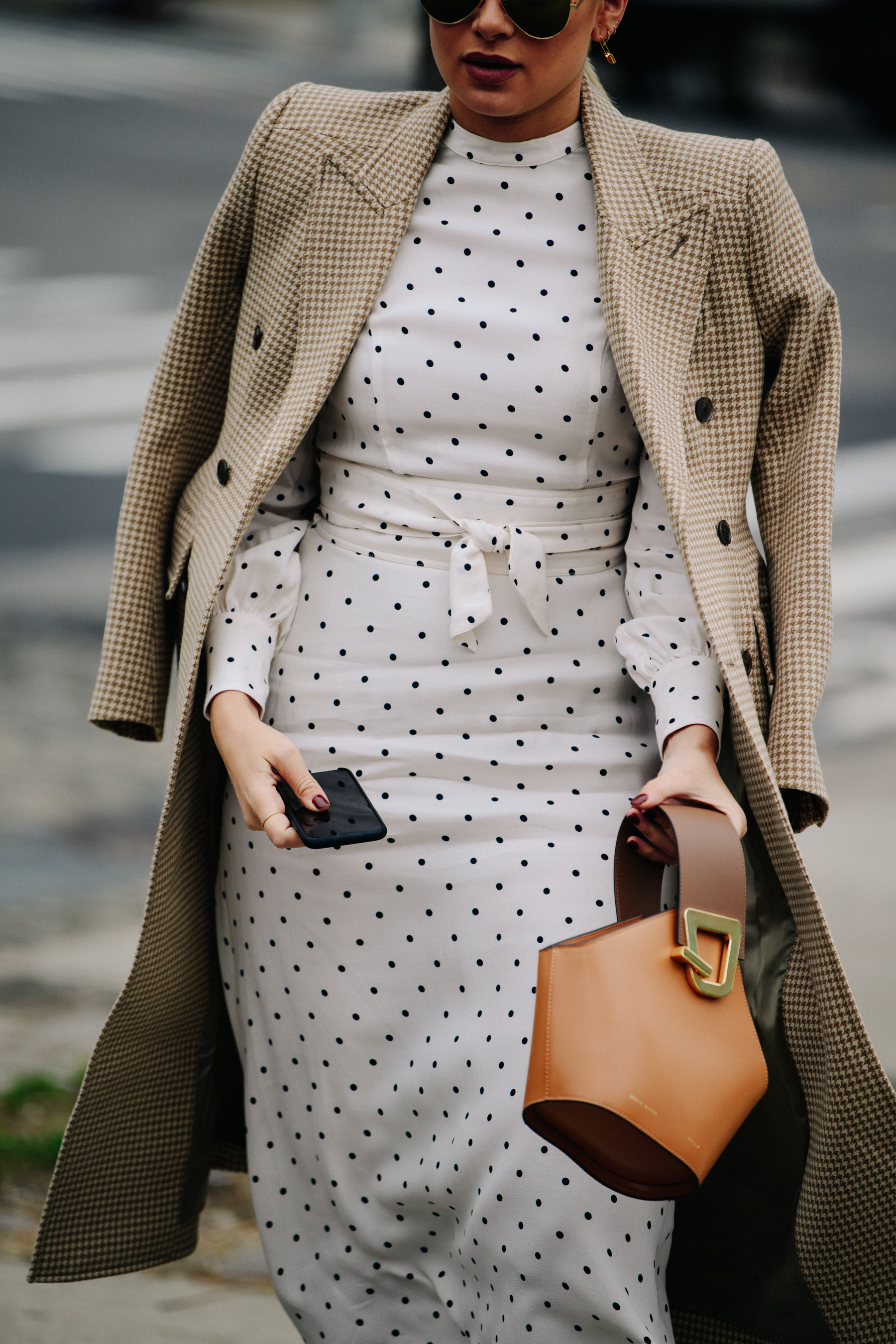 Woman carrying brown leather bag