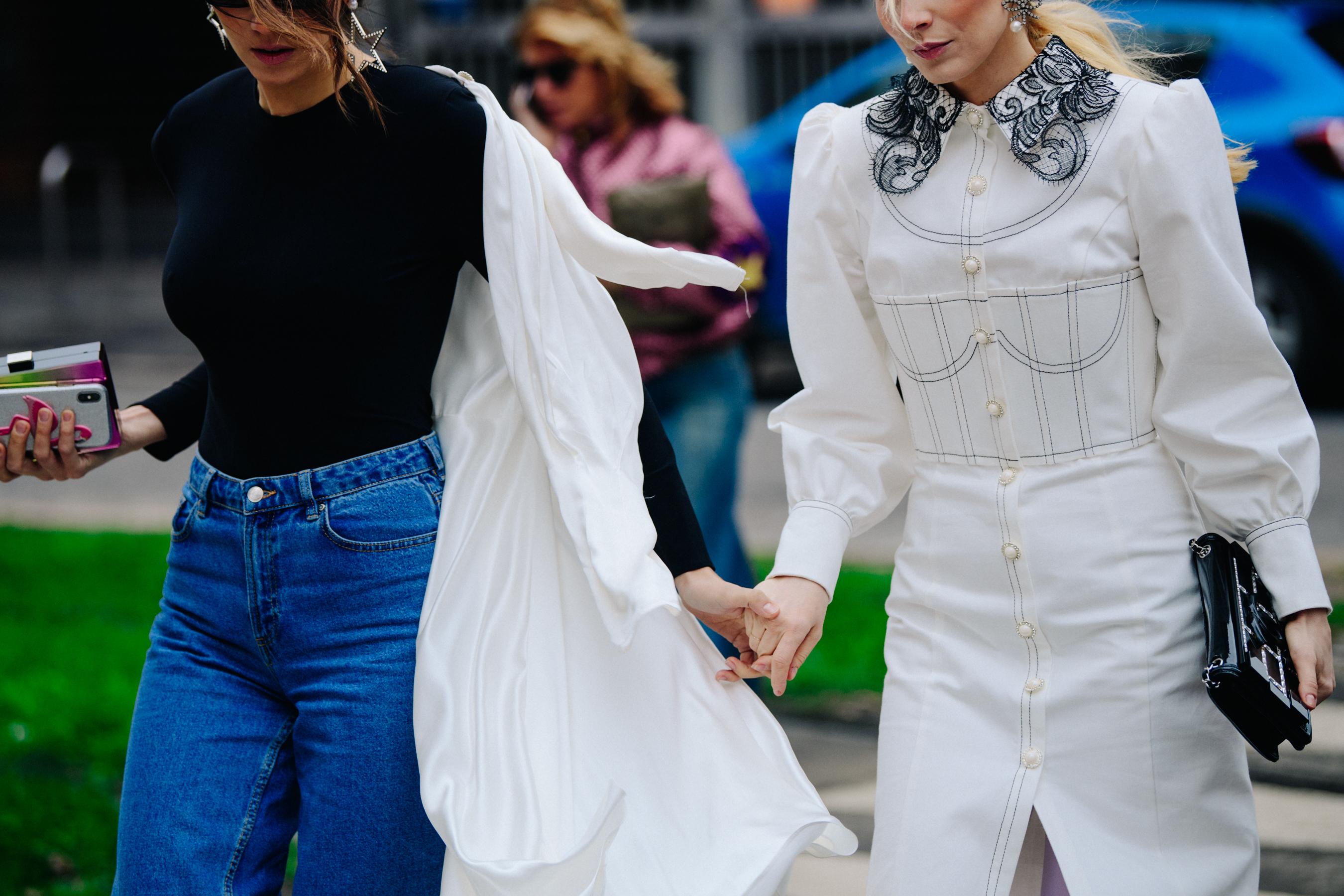 Two women wearing long white tops