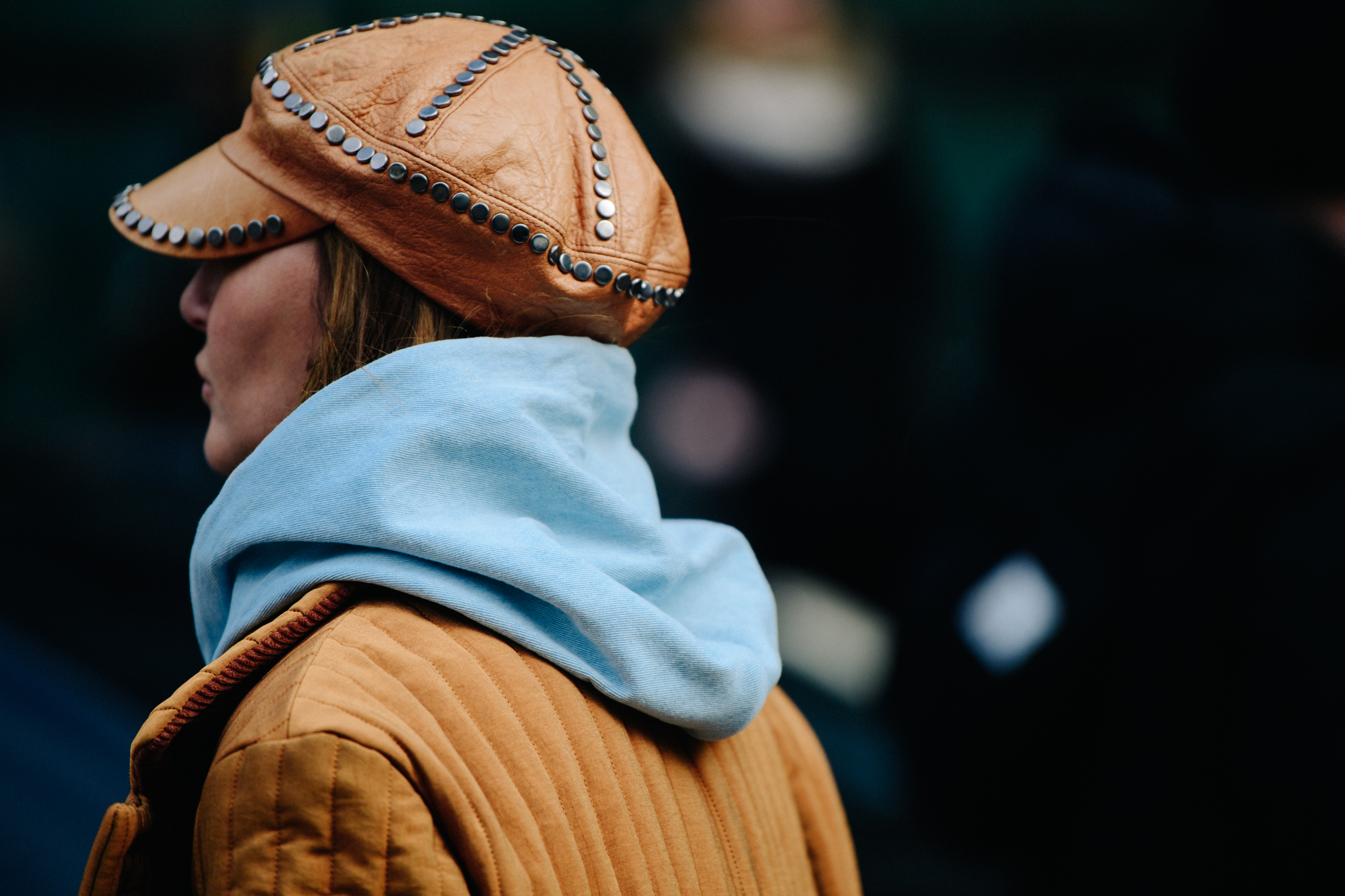 Woman wearing studded leather hat