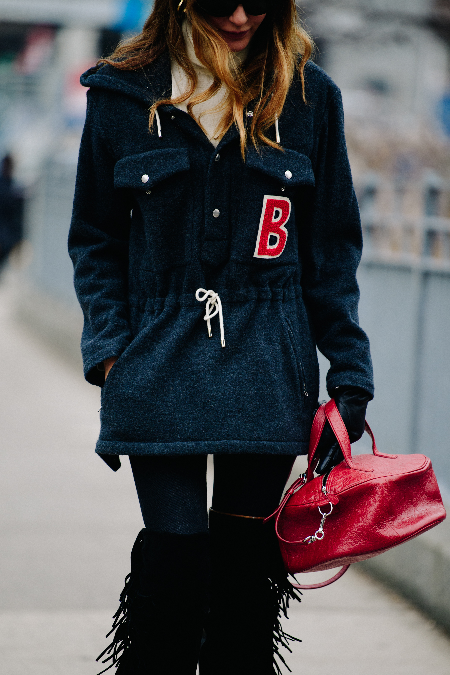 Woman carrying red circular bag