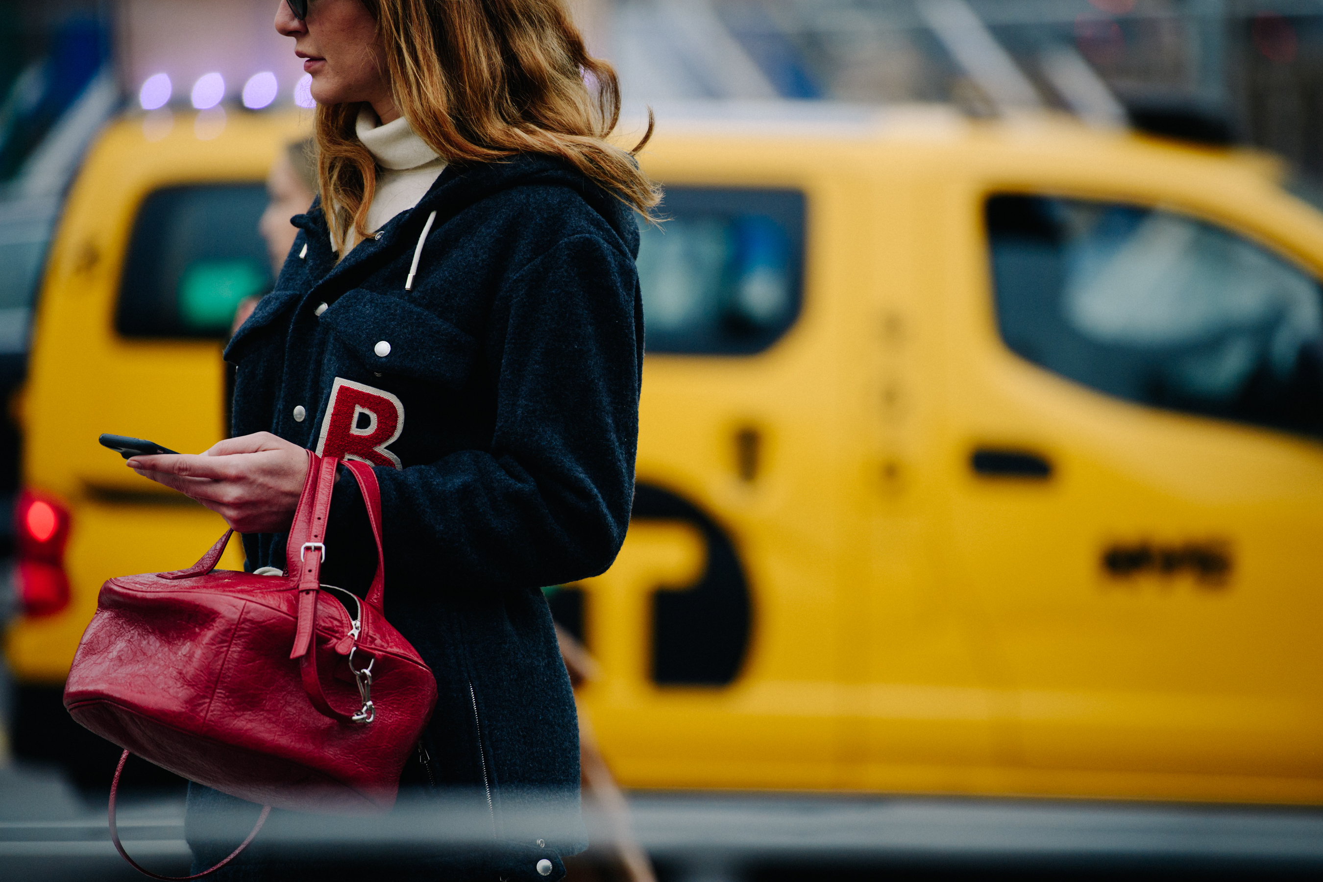 Woman carrying red handbag