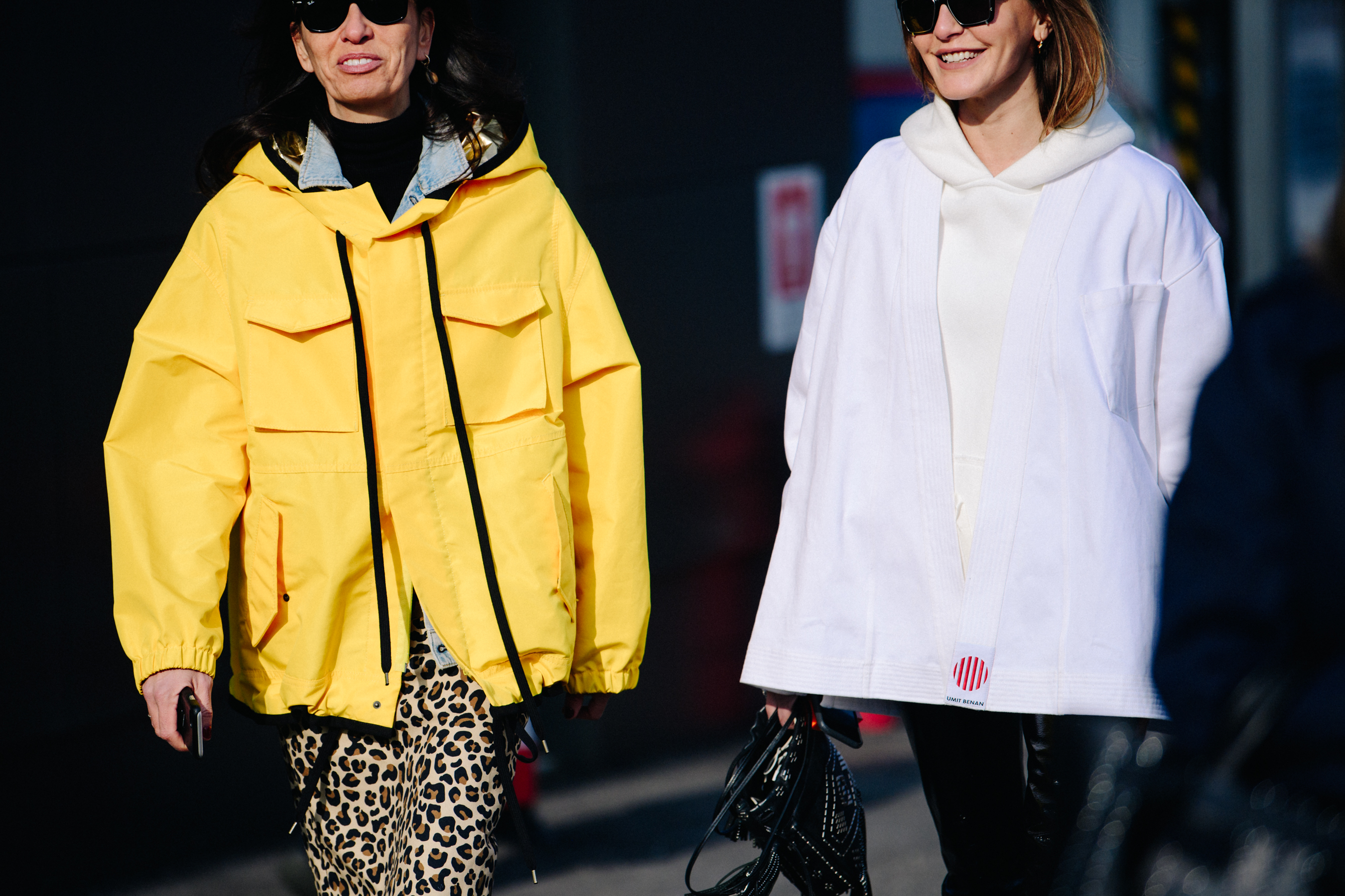 Two women wearing black sunglasses