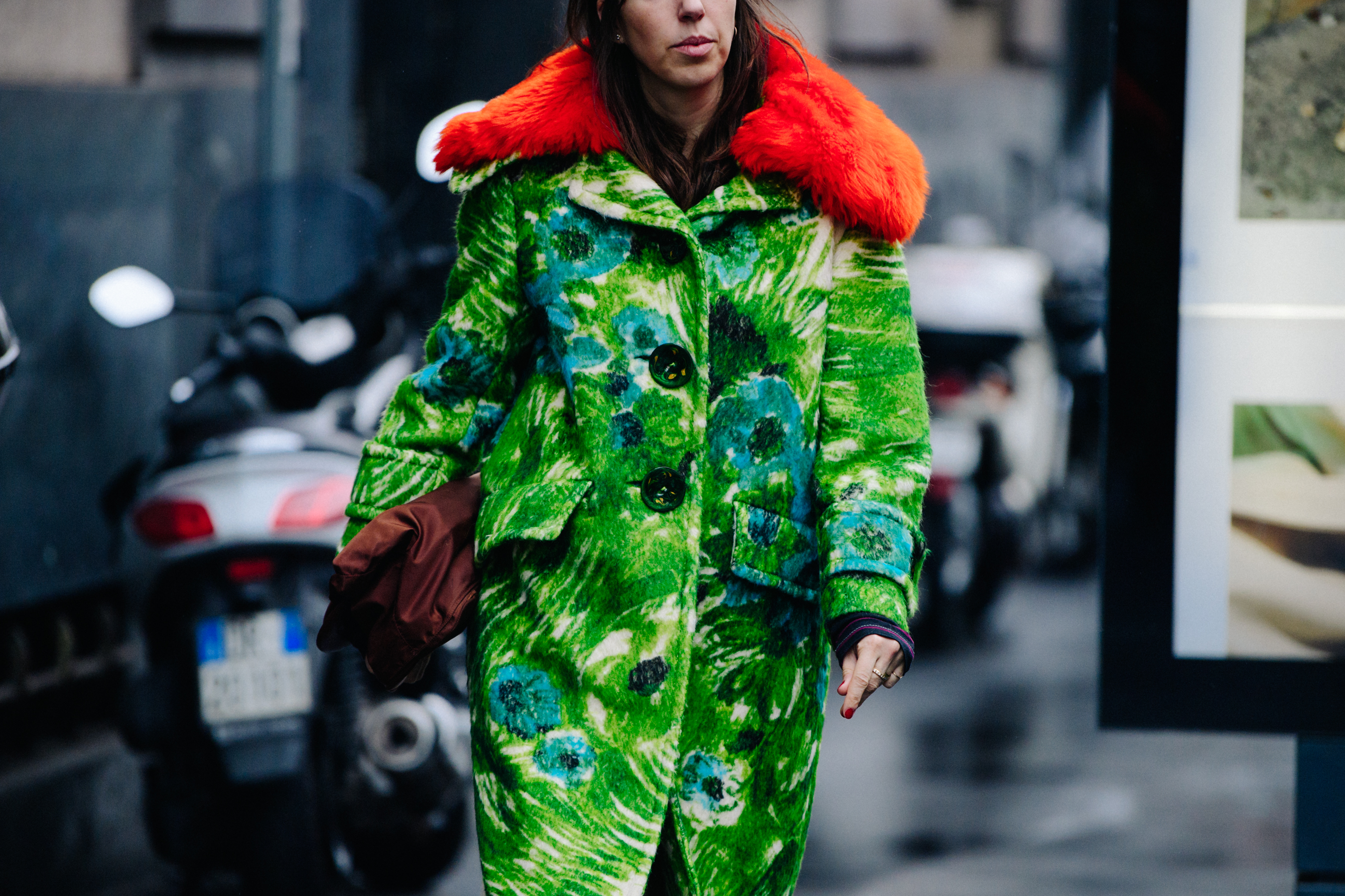 Woman wearing floral green coat