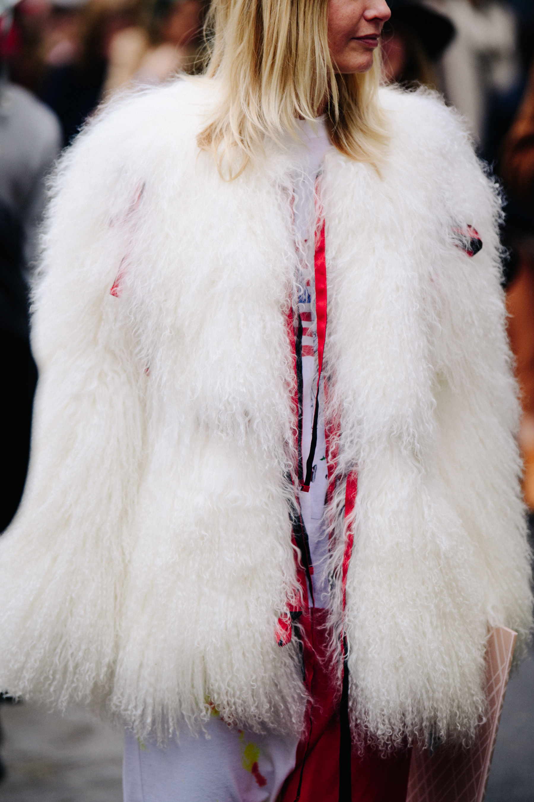 Woman wearing white fur jacket