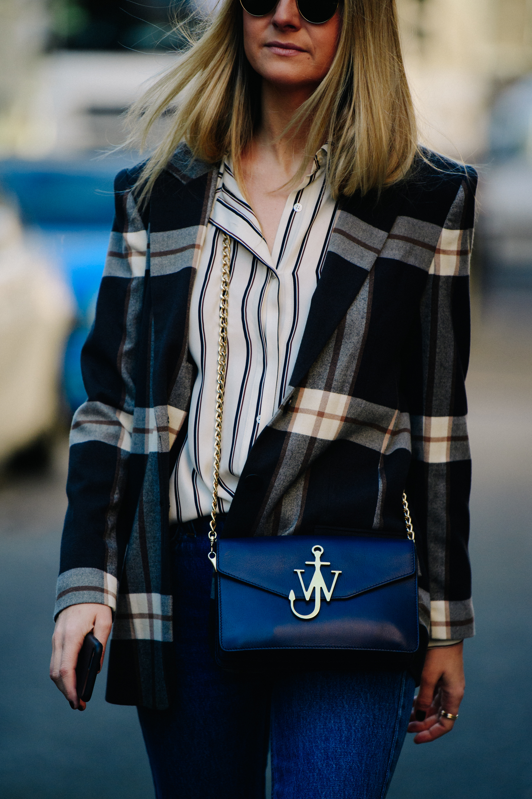 Woman carrying blue JW Anderson bag