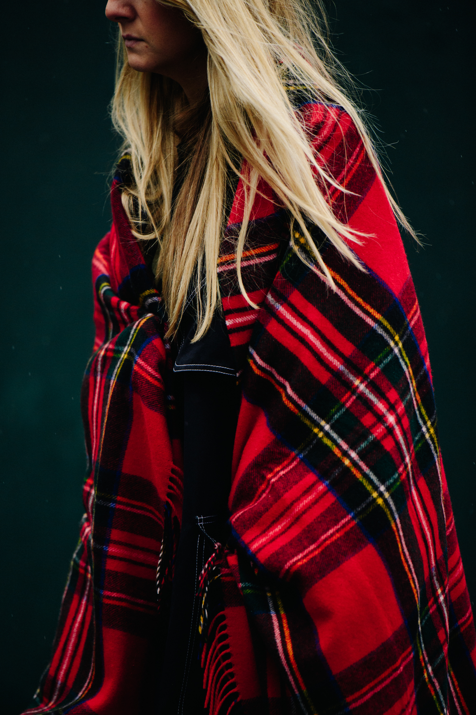 Woman wearing tartan blanket around her