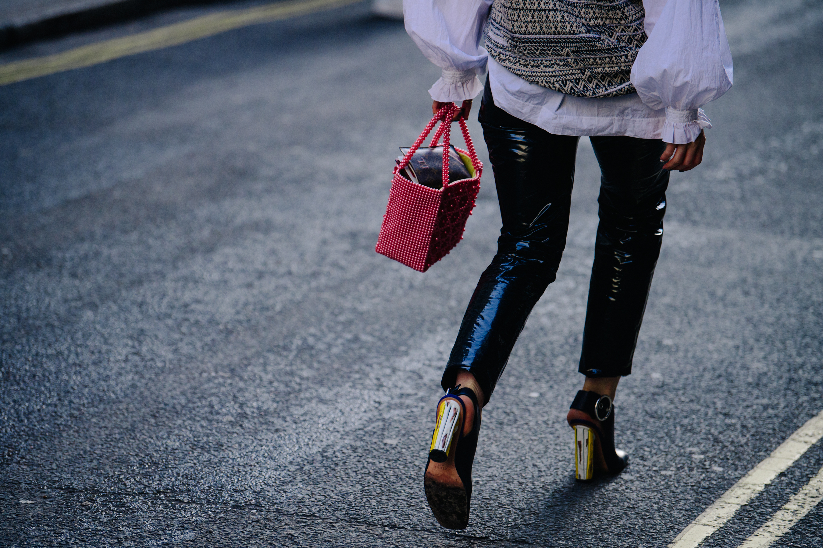 Woman wearing black patent pants