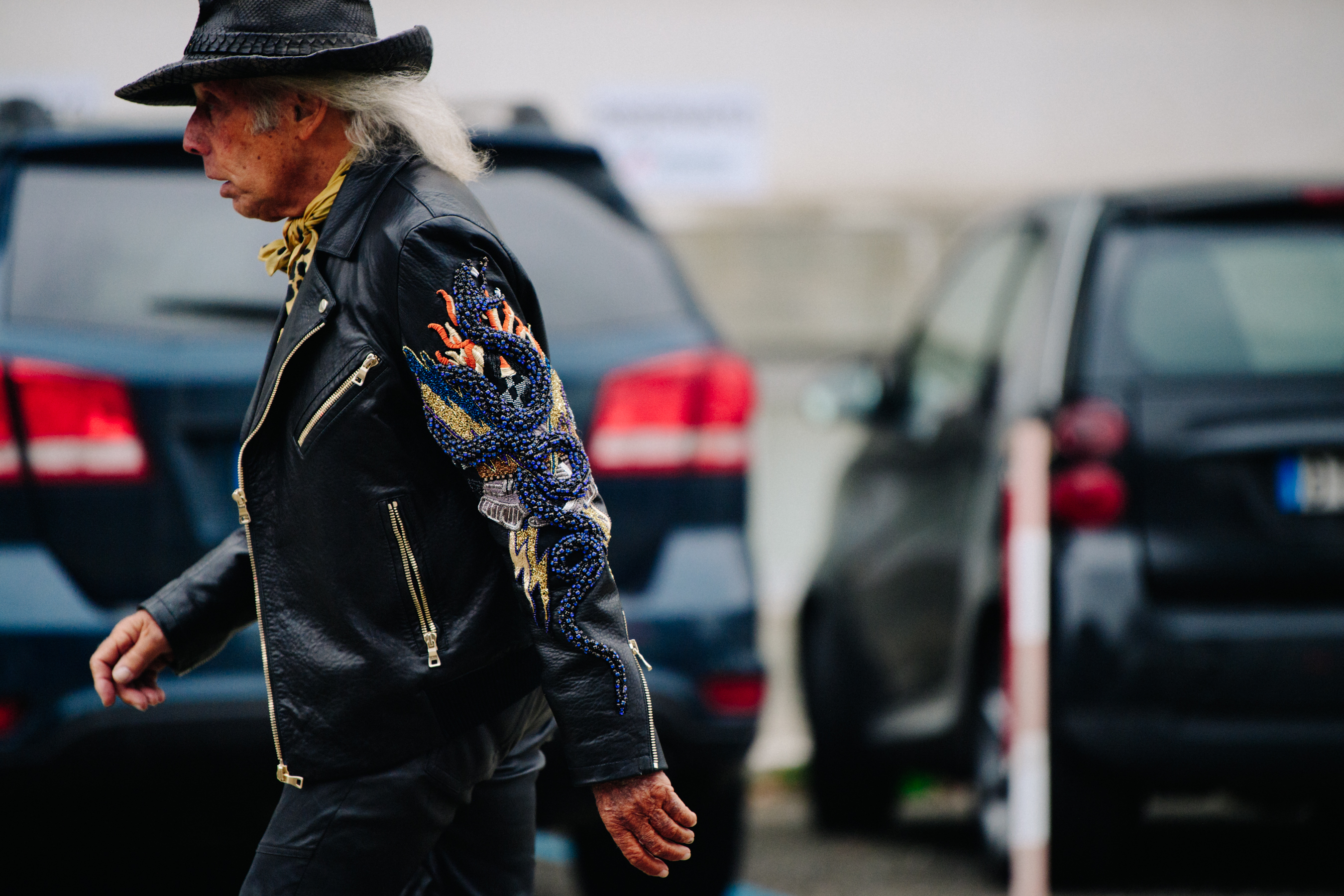 American man wearing leather beaded jacket