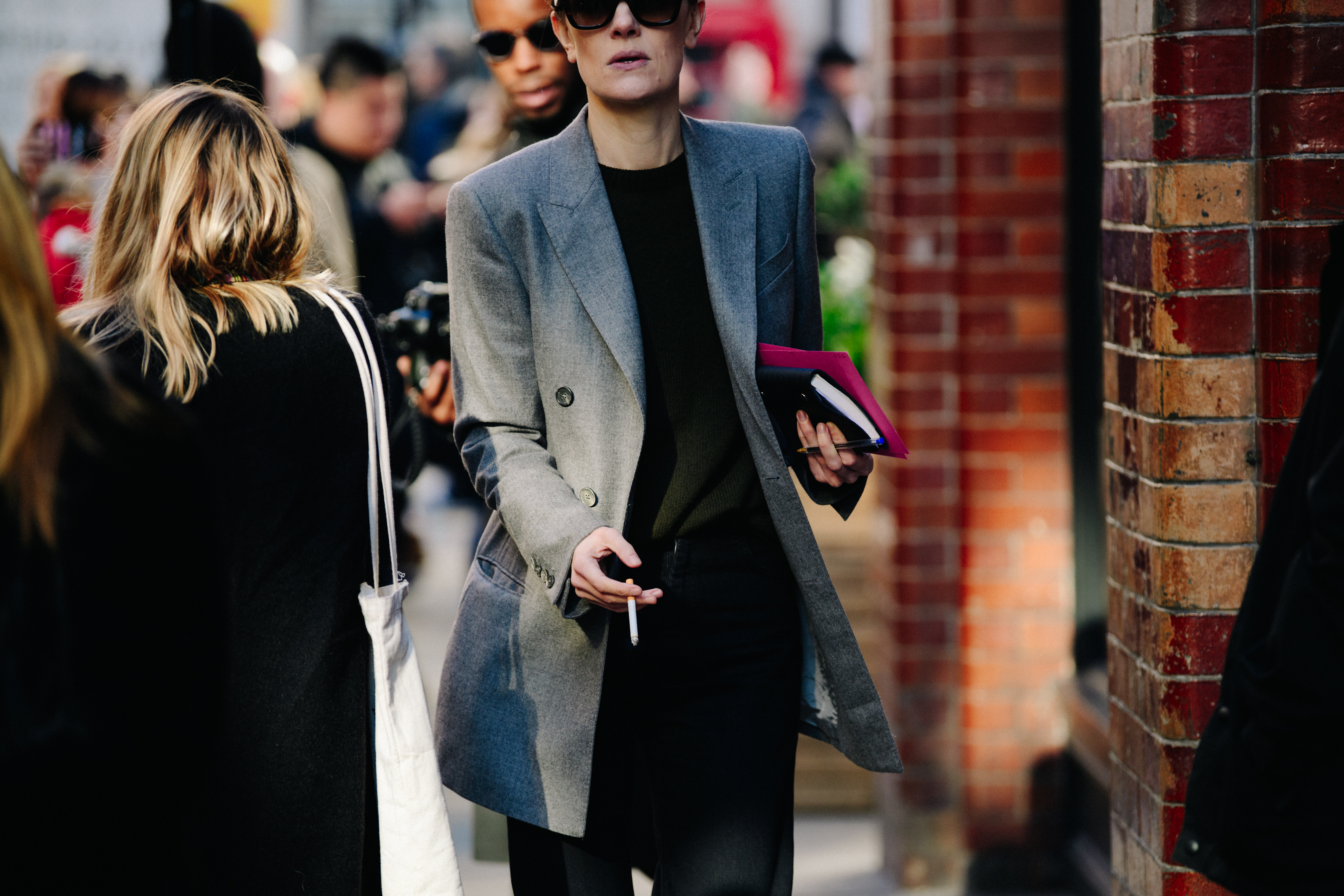American editor wearing grey suit jacket