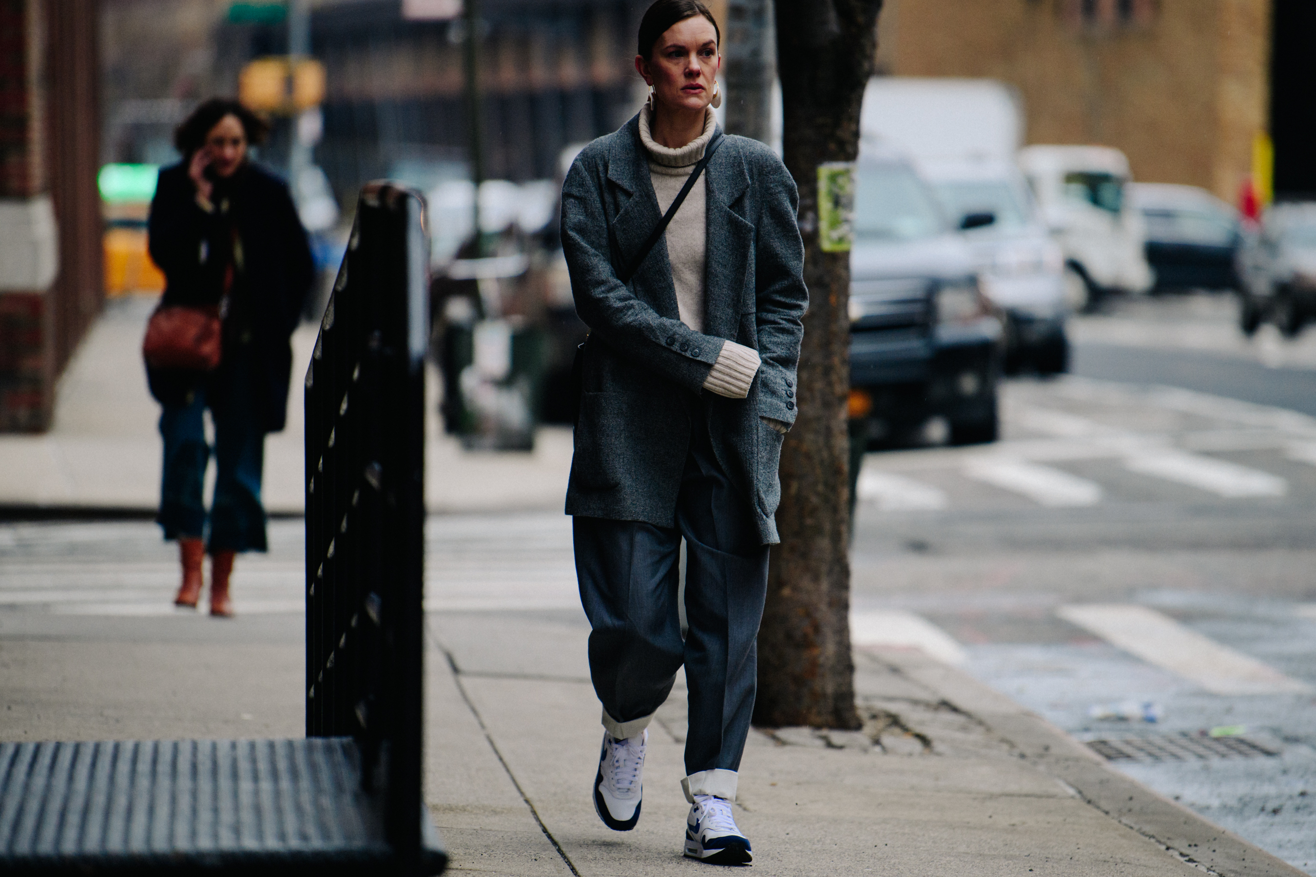 Editor wearing grey coat and pants