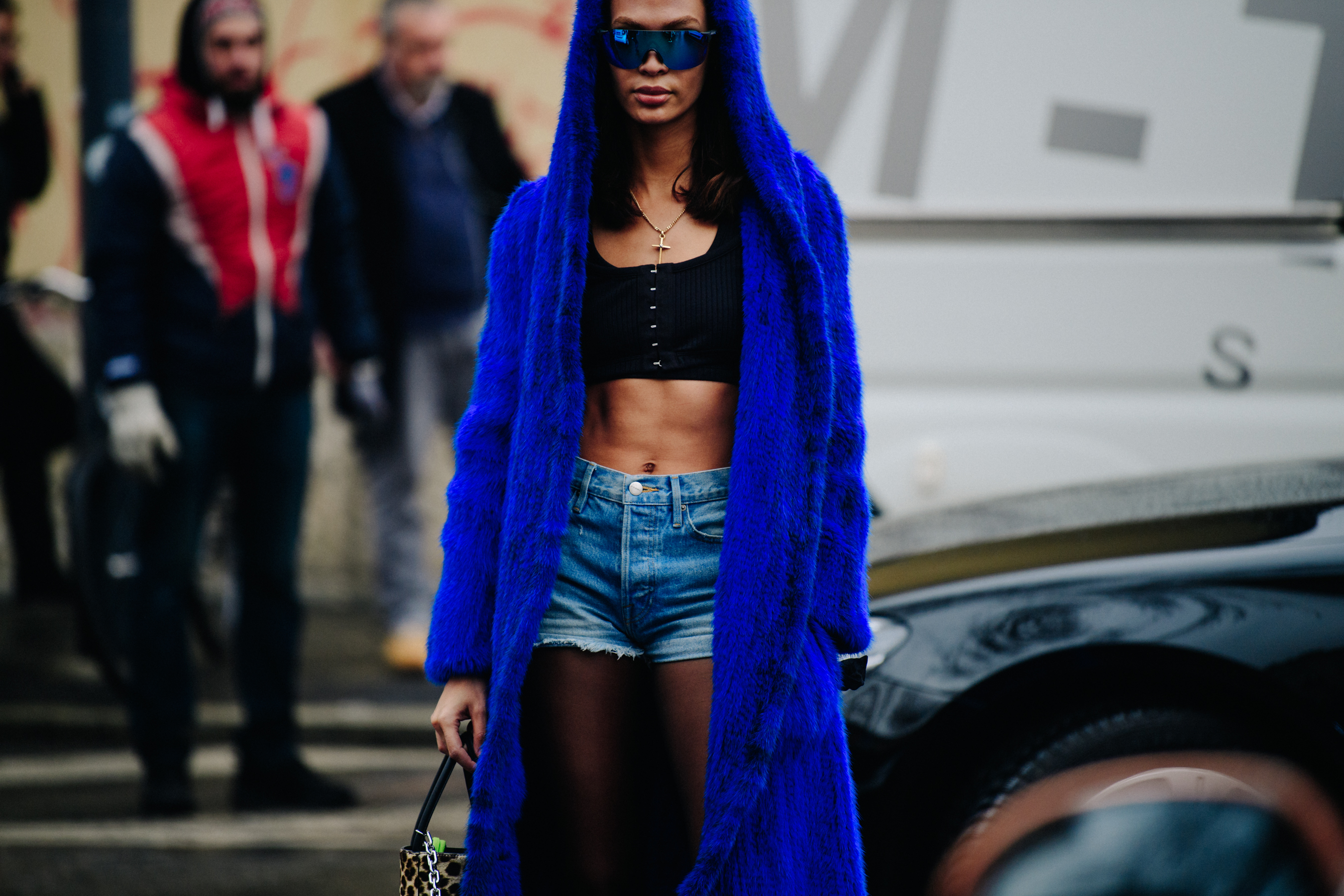 Model wearing long blue fur hoodie