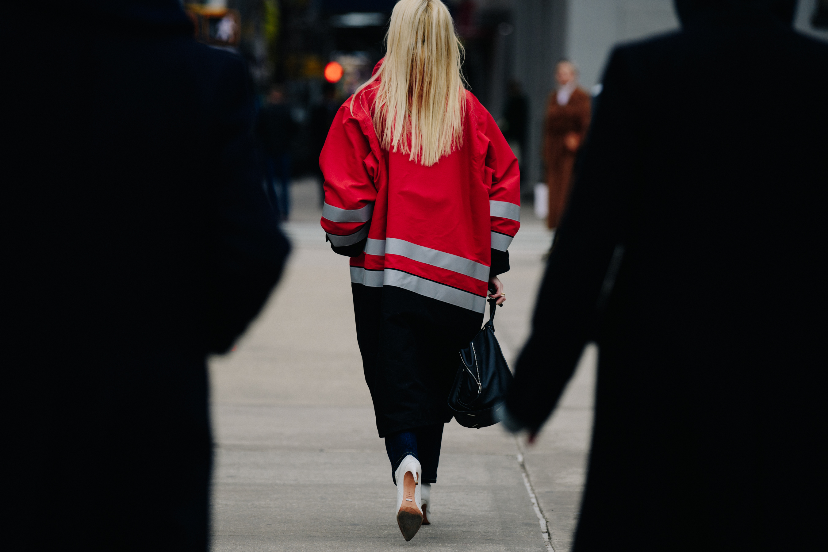 Woman wearing red Balenciaga coat