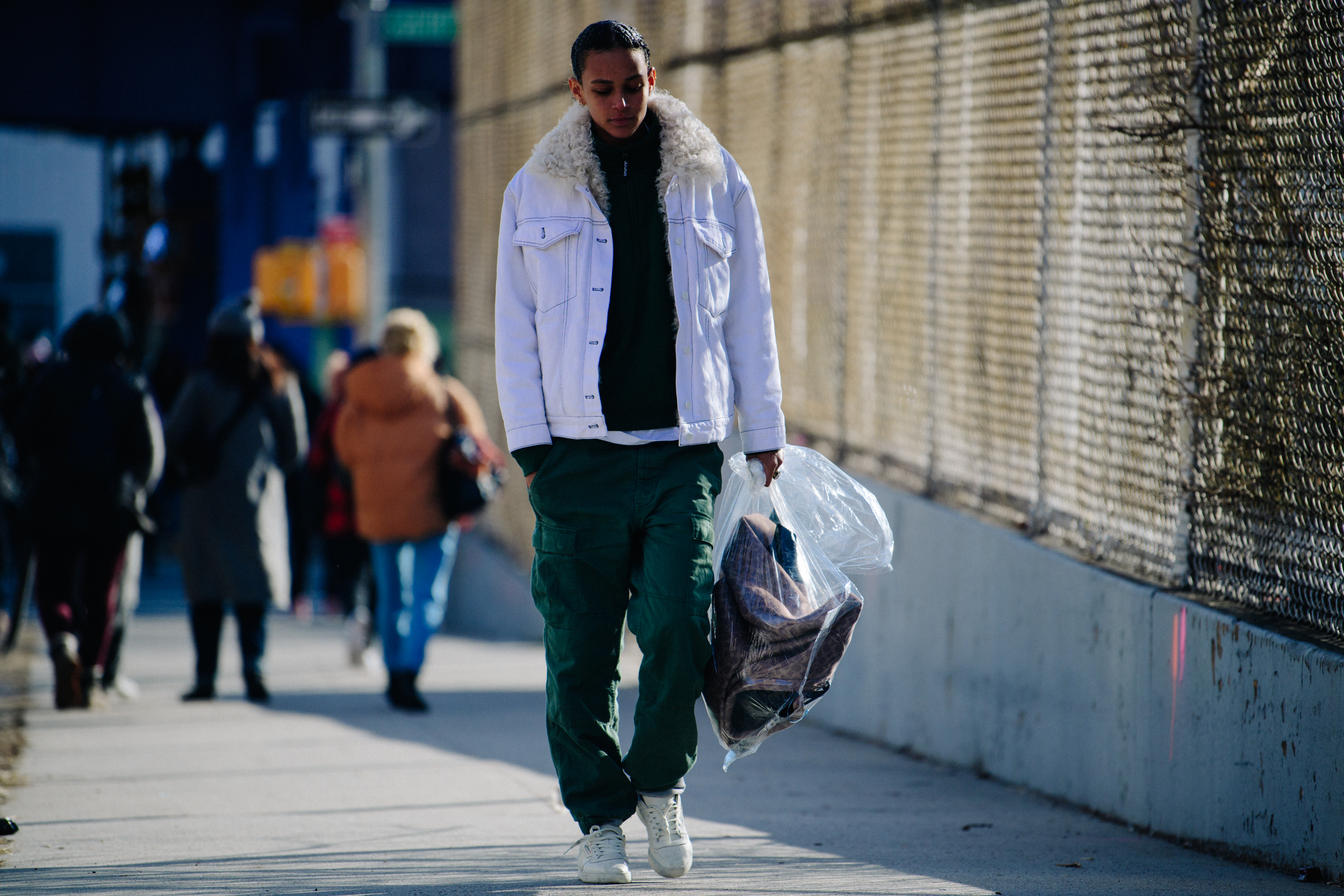 American model wearing white denim jacket