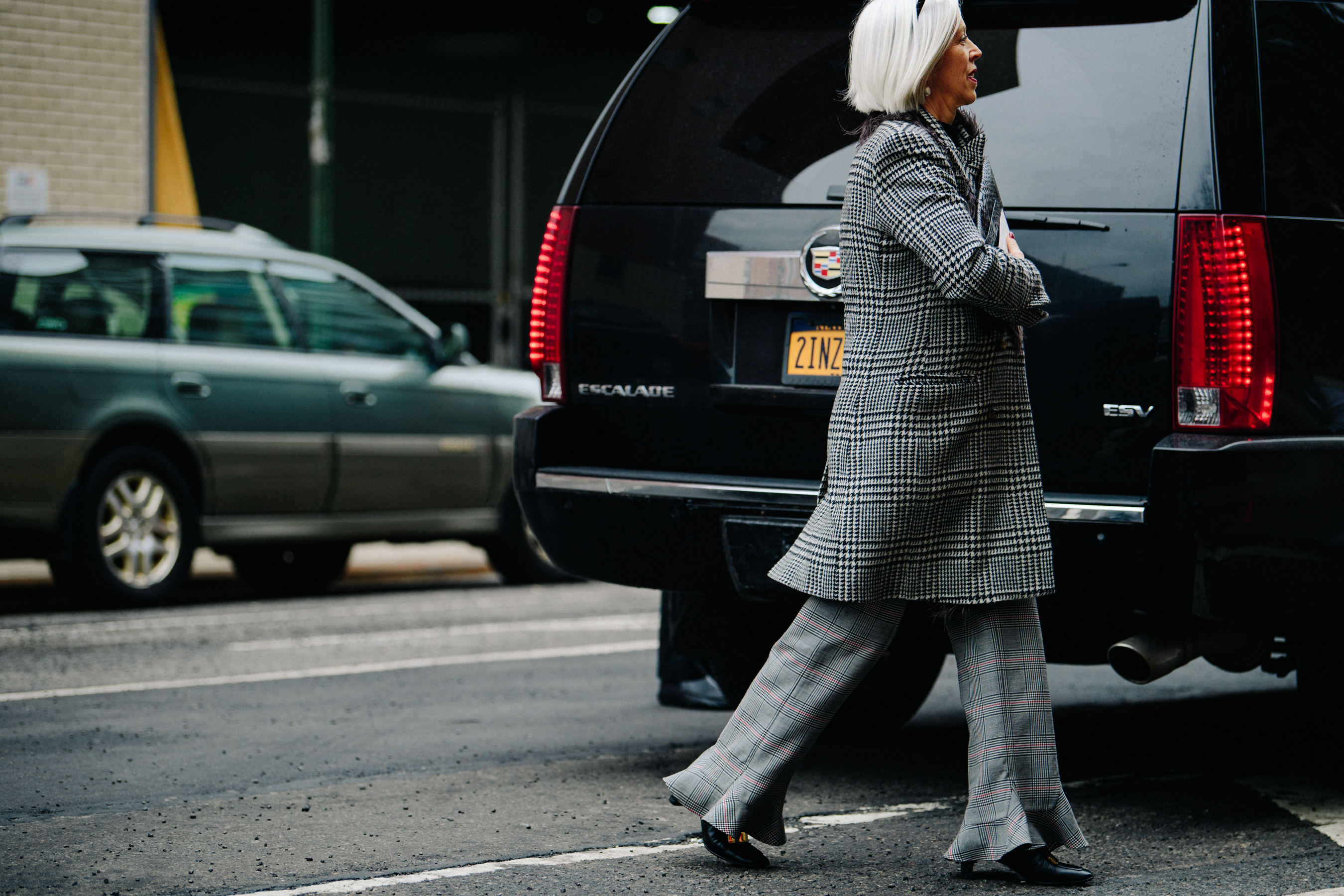 Woman wearing white and black check coat
