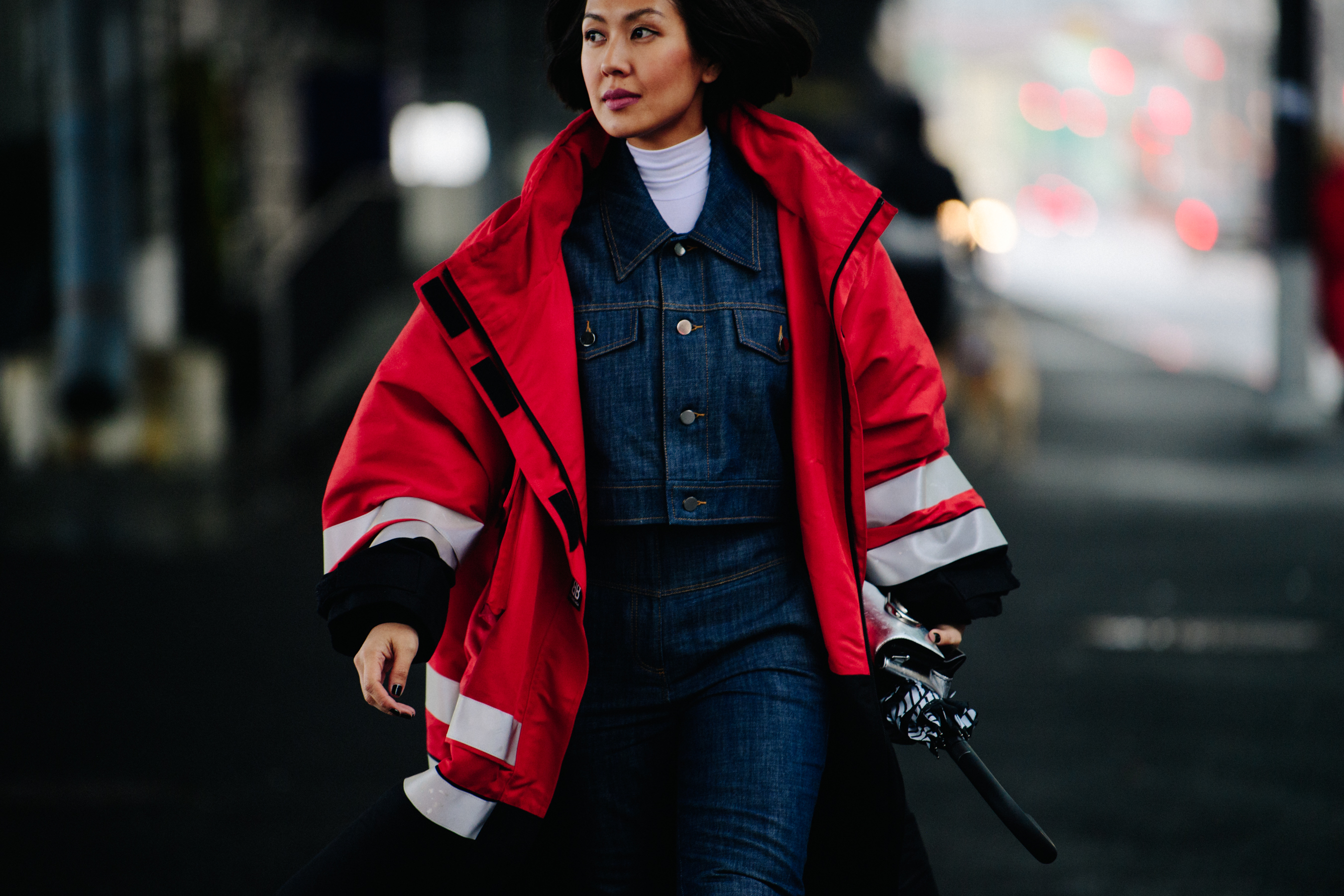 Woman wearing denim outfit under red coat