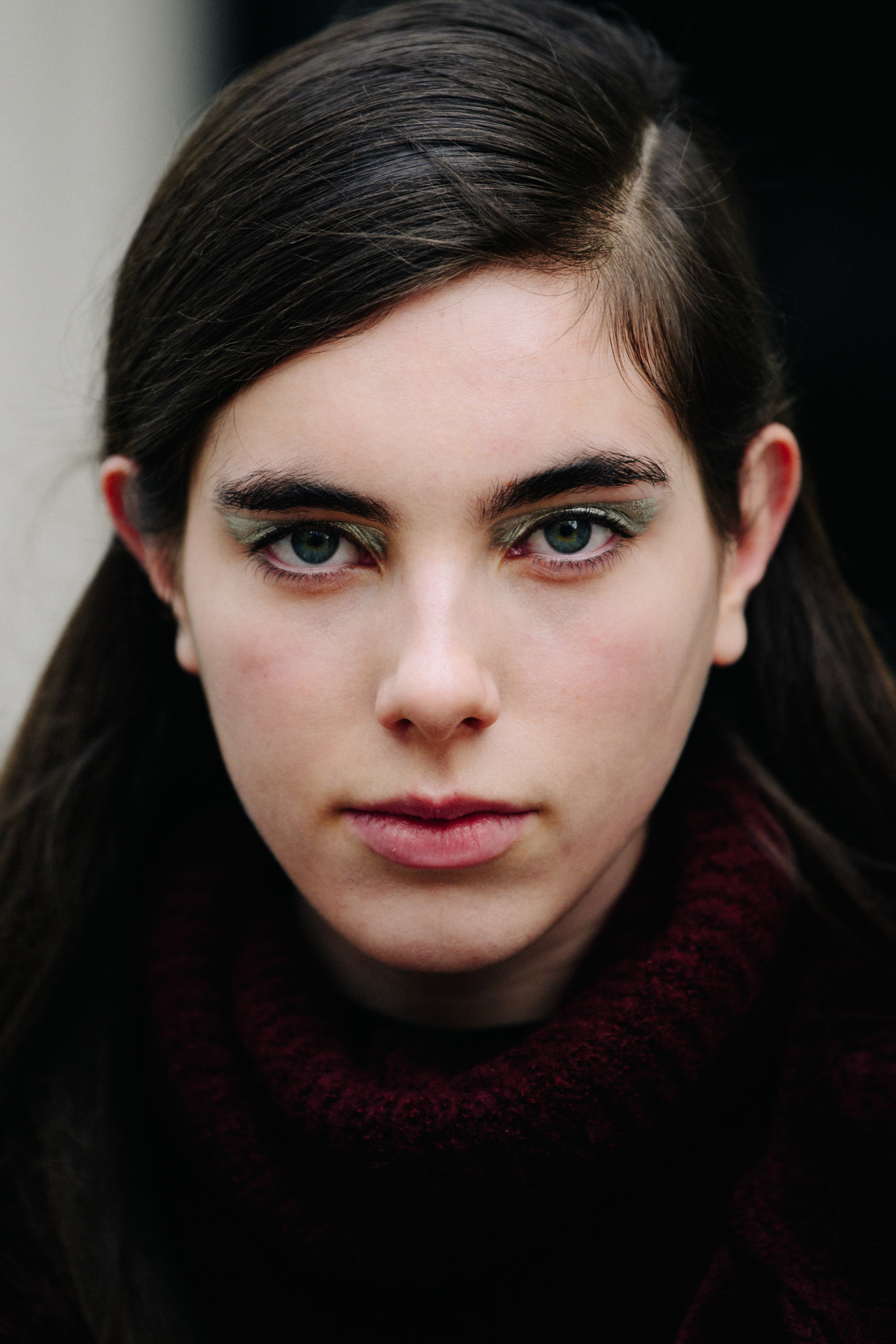 Portrait of British model wearing green eye shadow
