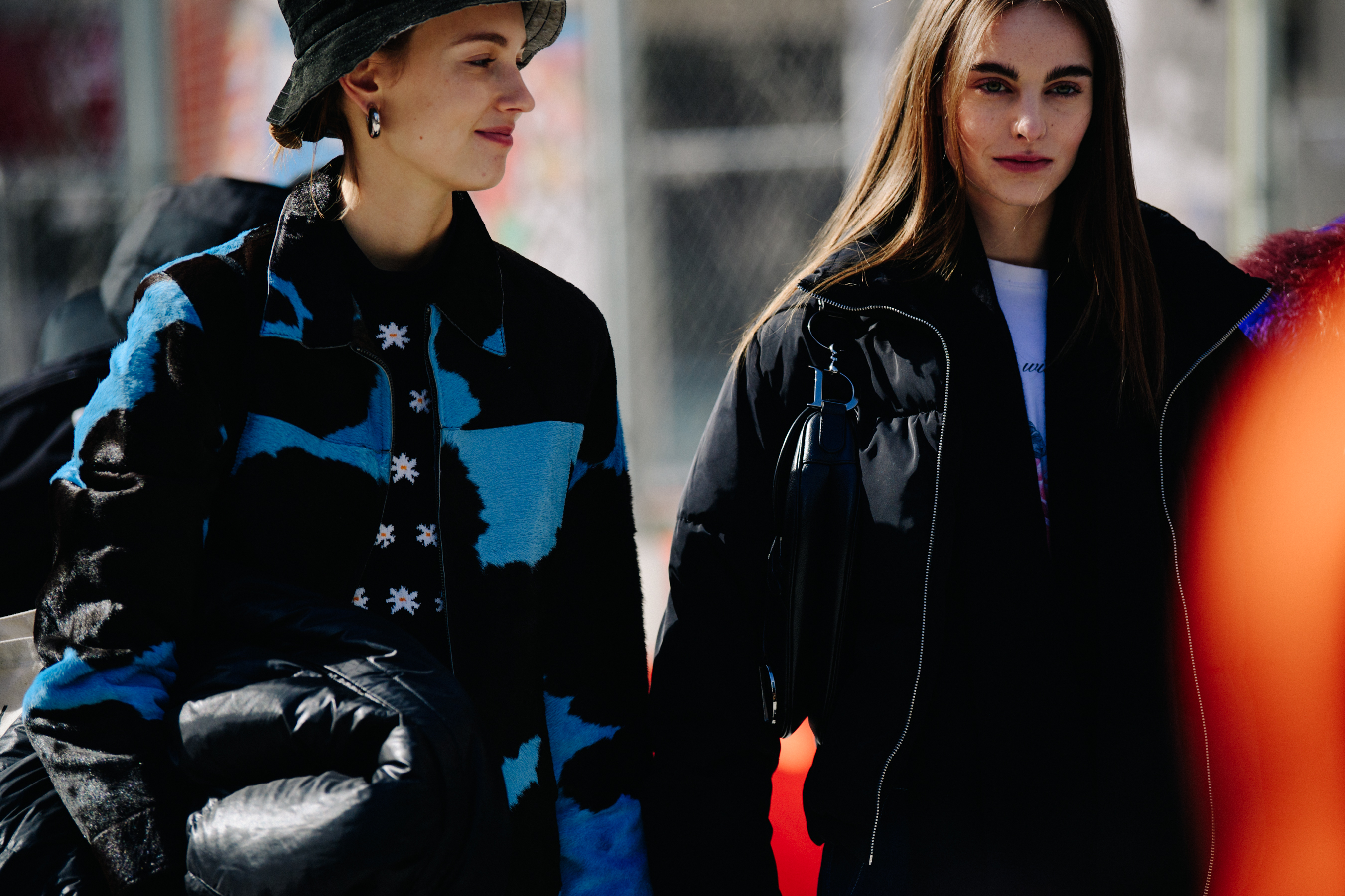 Two models wearing dark jackets