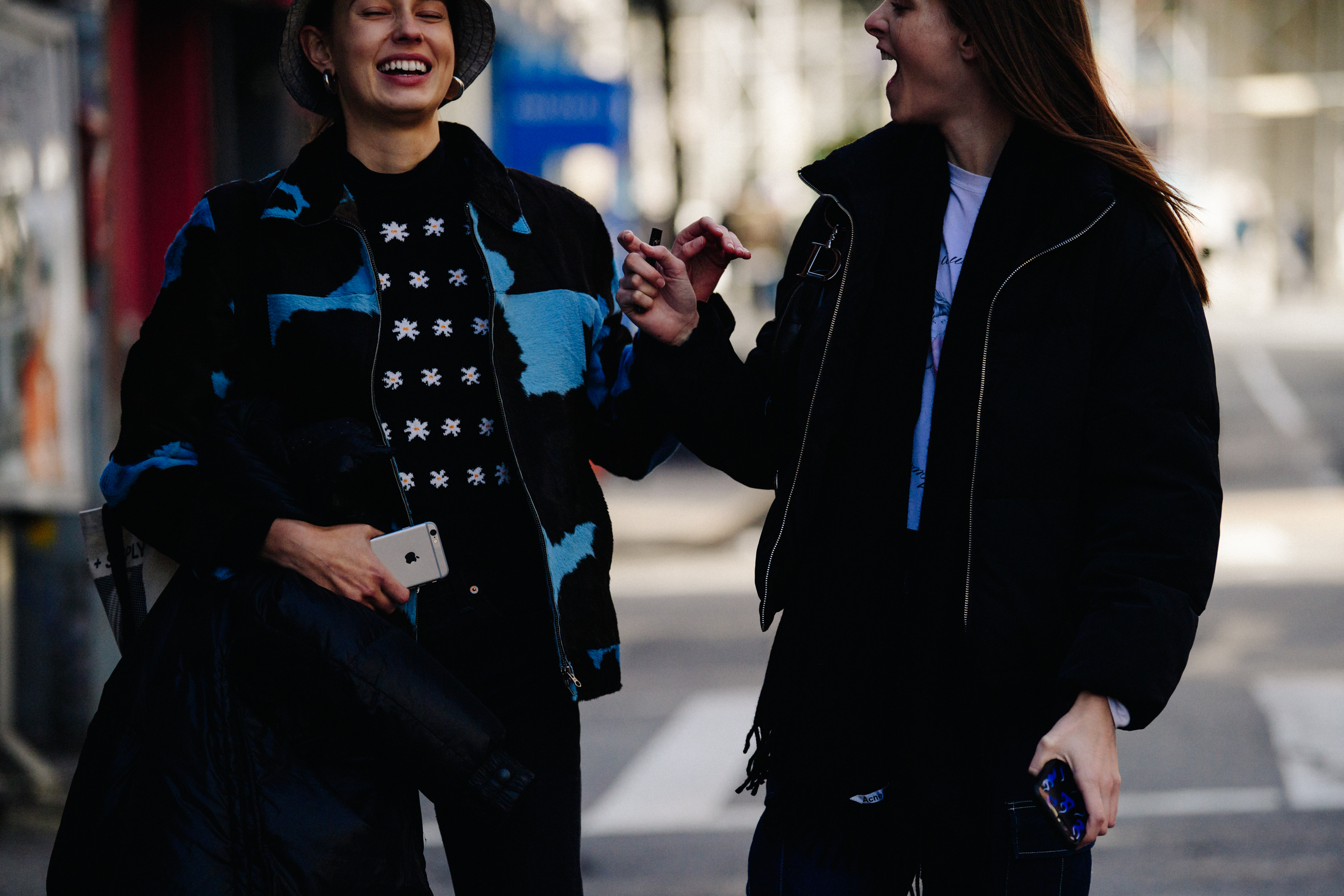 Two models wearing dark jackets