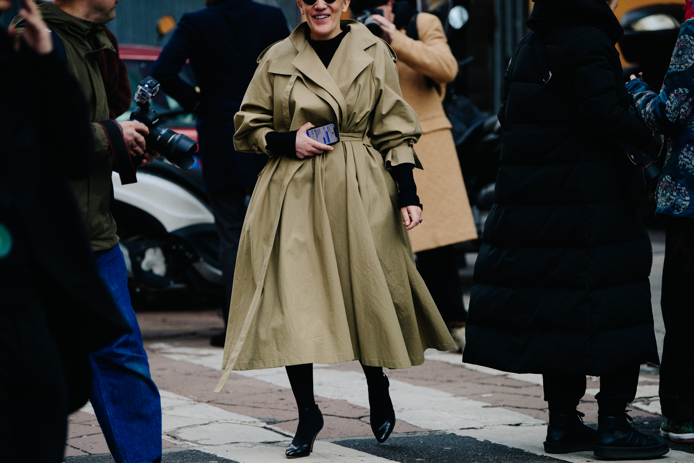 Woman wearing long tan coat