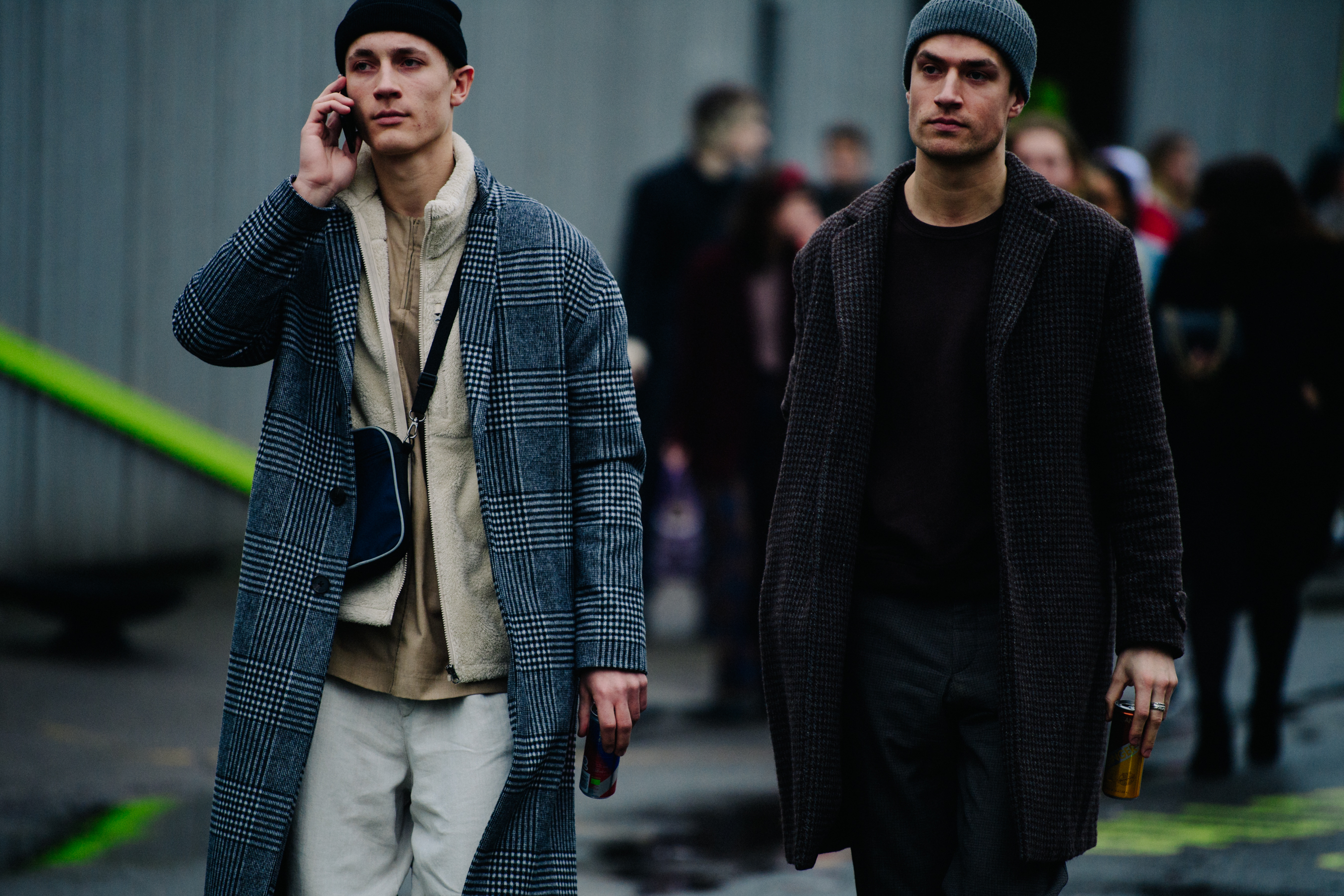Two men wearing long wool coats