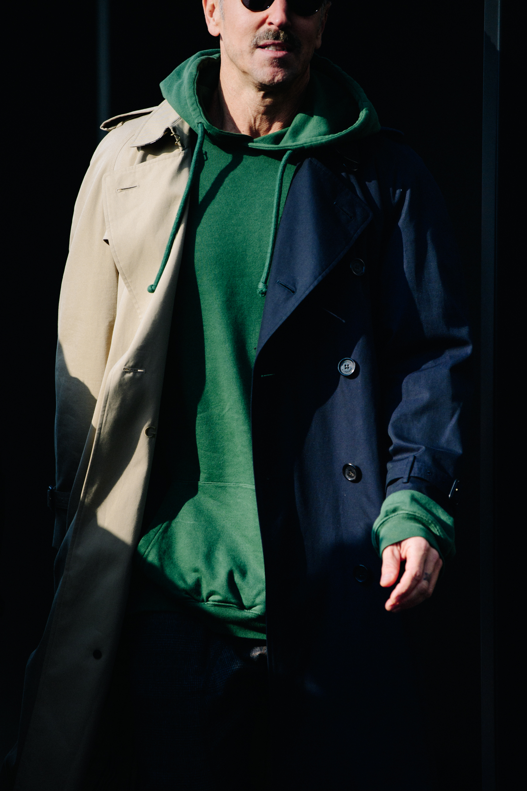 Man wearing black and tan trench coat