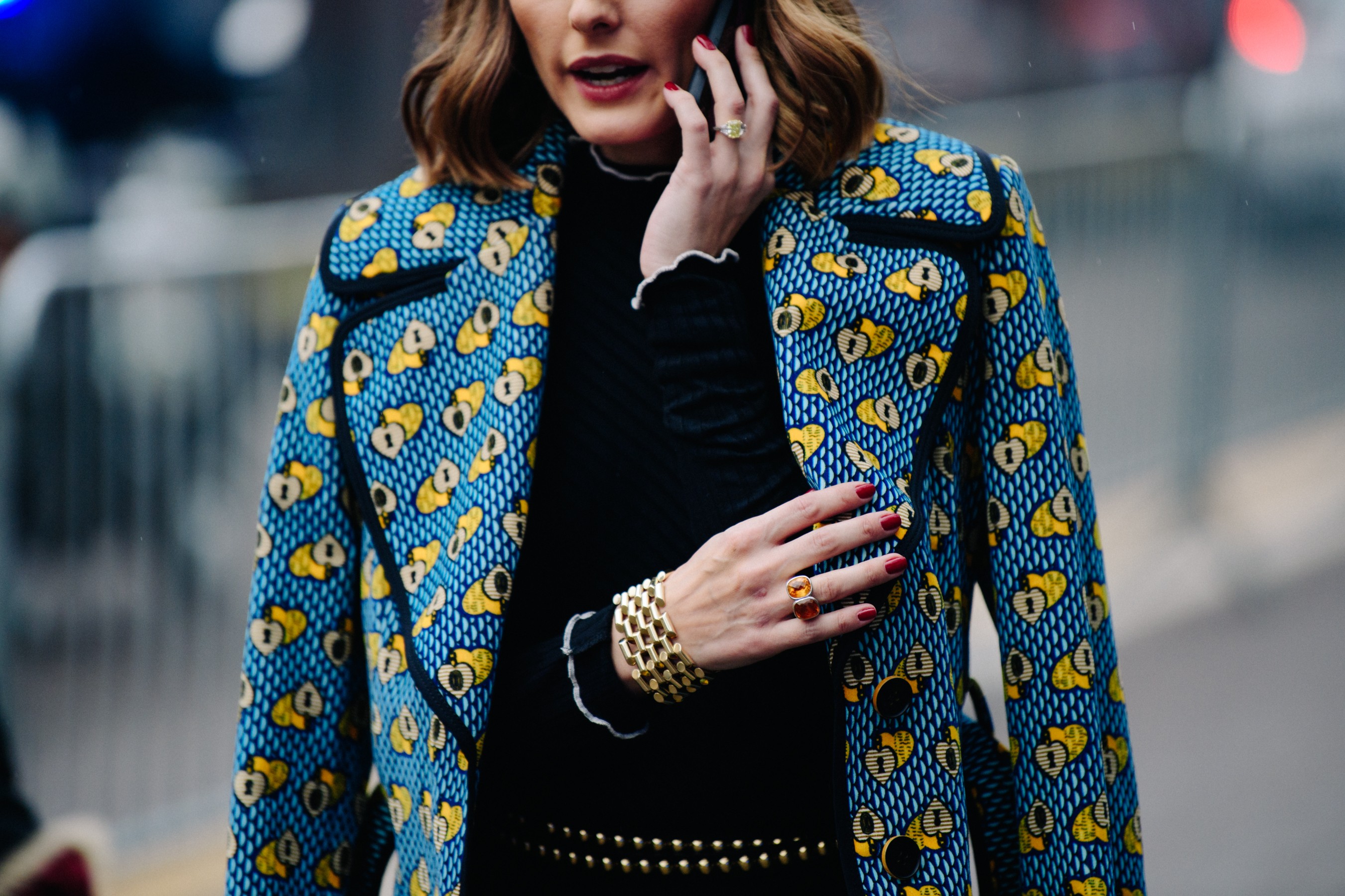 Woman wearing blue and gold coat