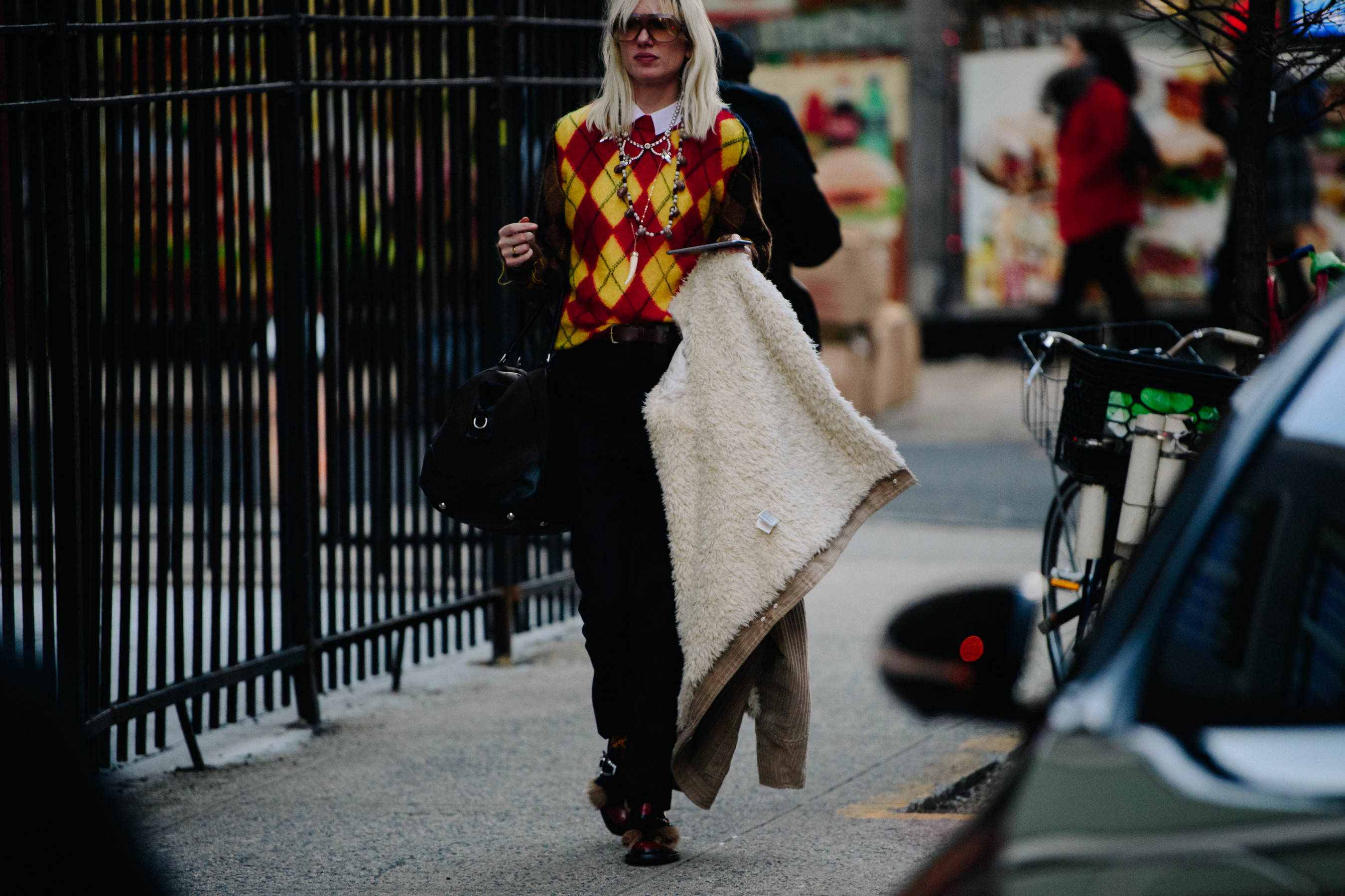 Woman wearing yellow and red wool jumper