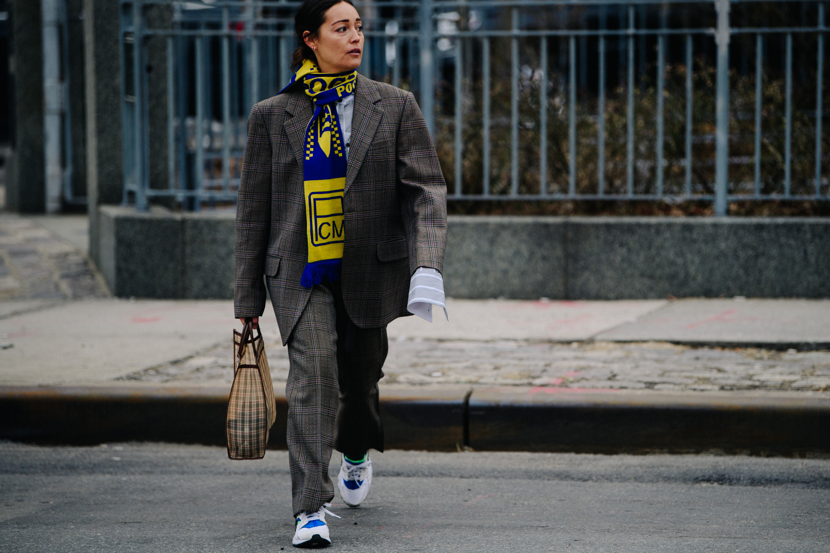 Woman wearing yellow and blue scarf