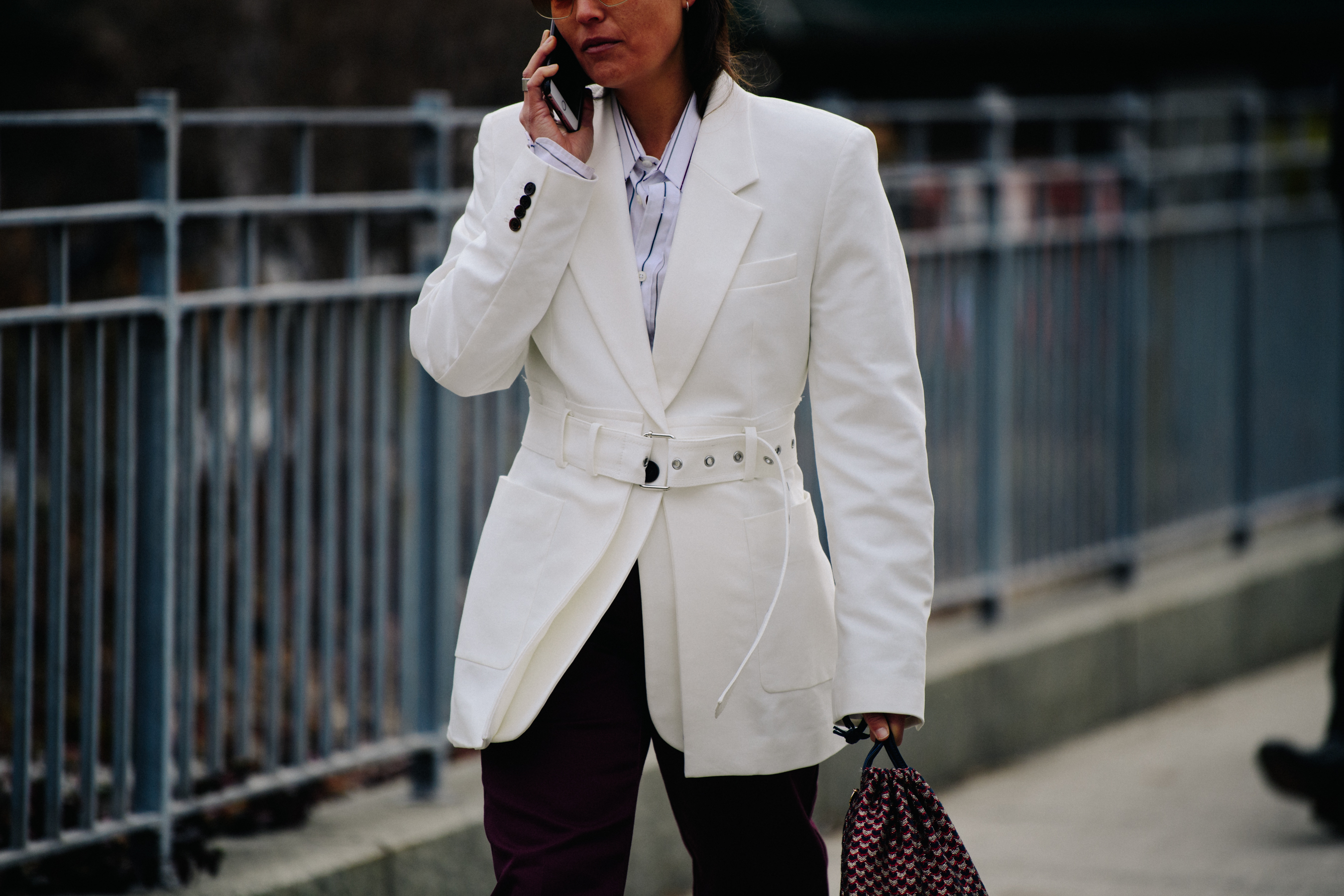 Woman wearing belted white suit jacket