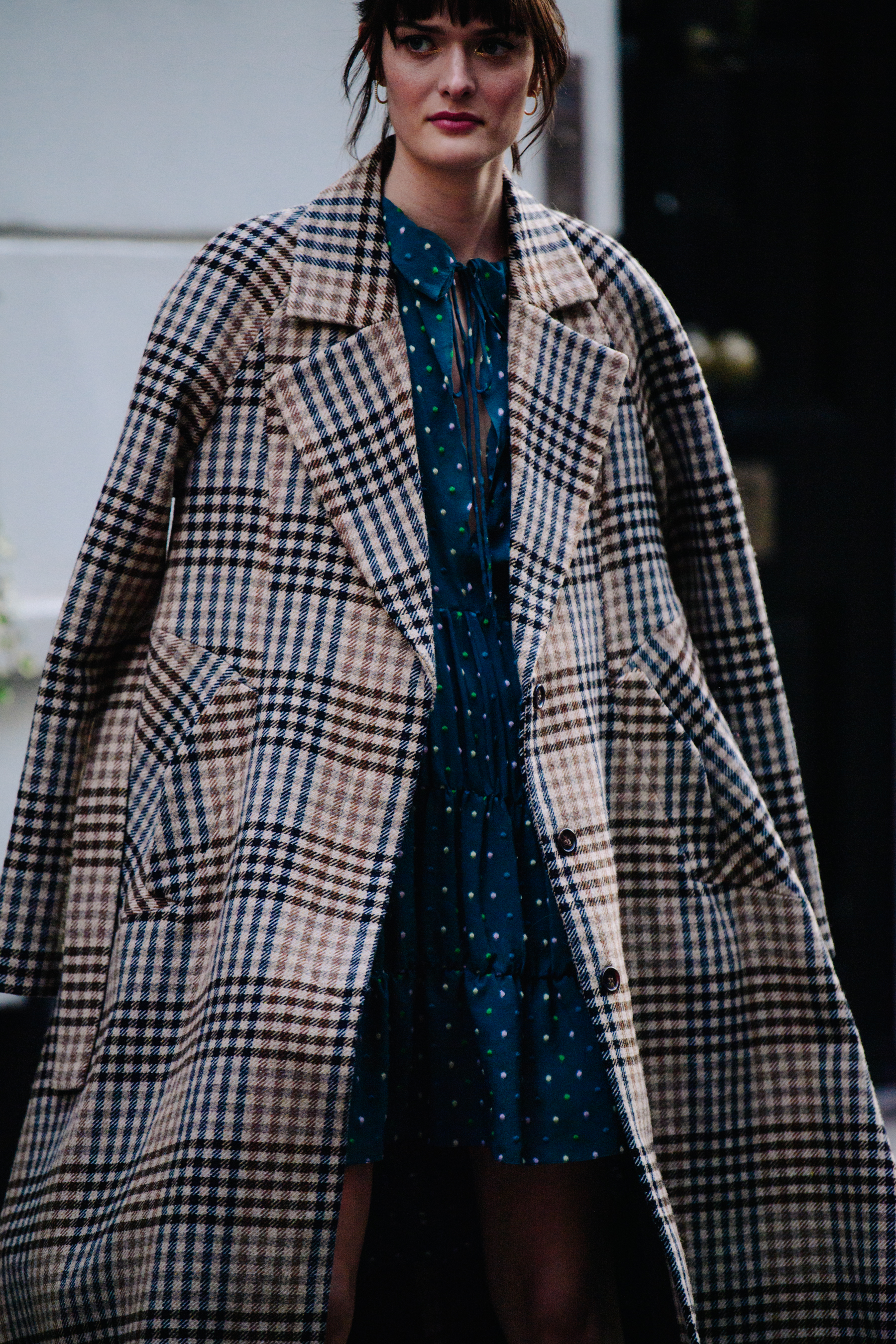 Model wearing long check coat