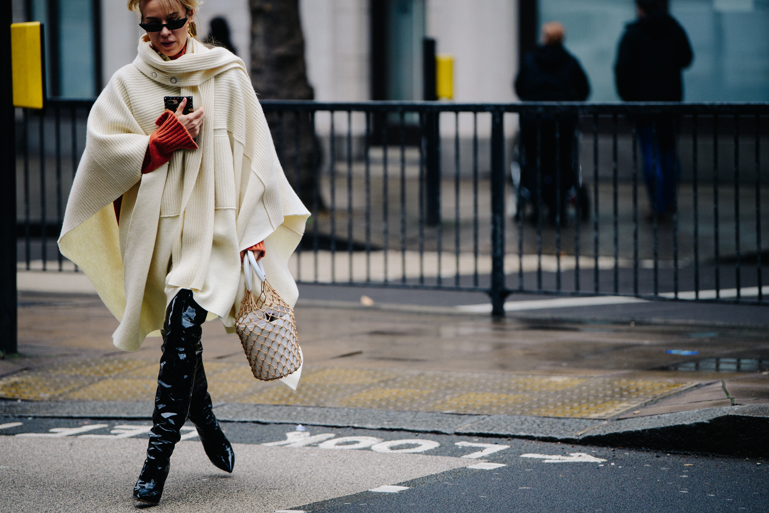 Woman wearing long white knitted jumper