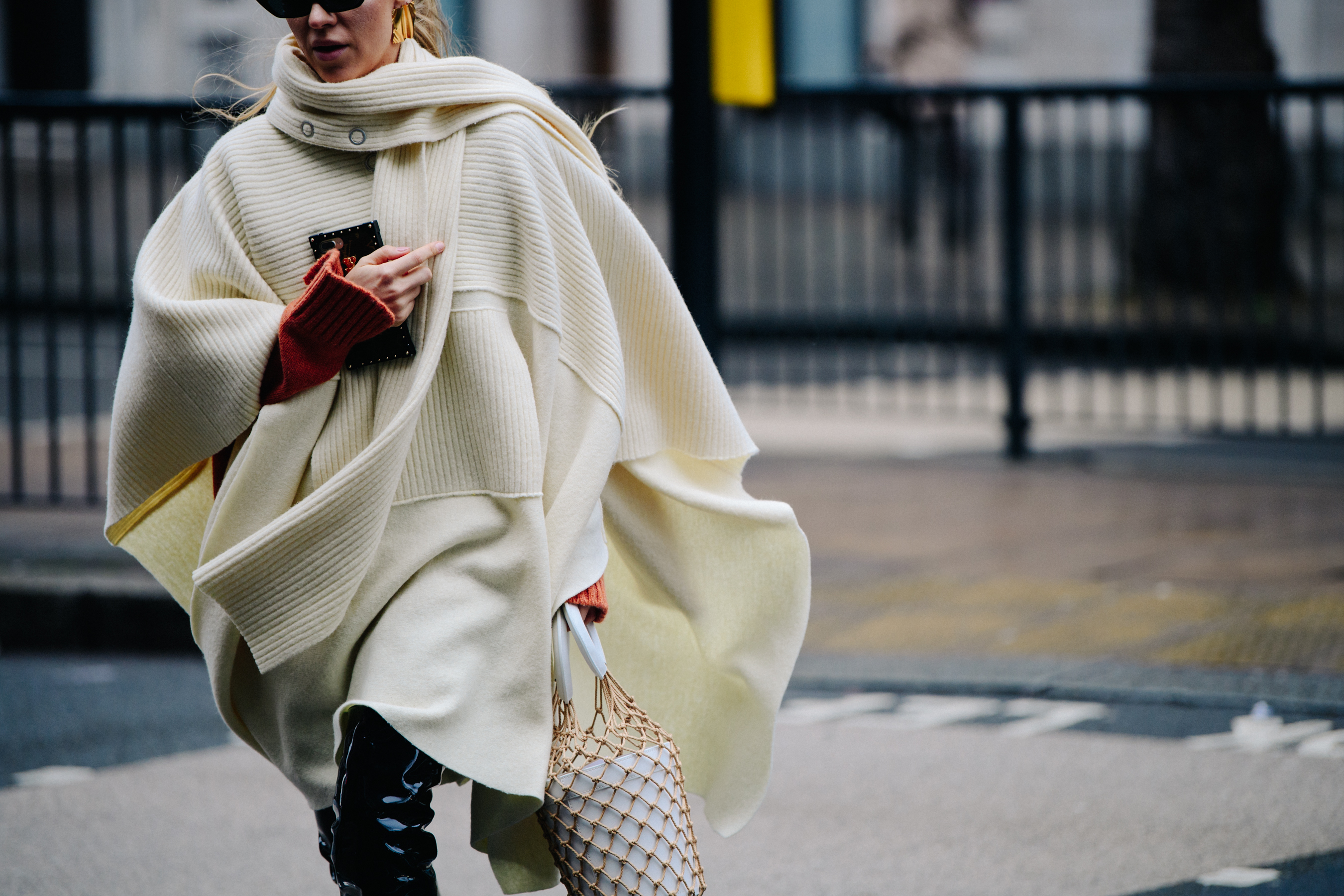 Woman wearing long white knitted jumper