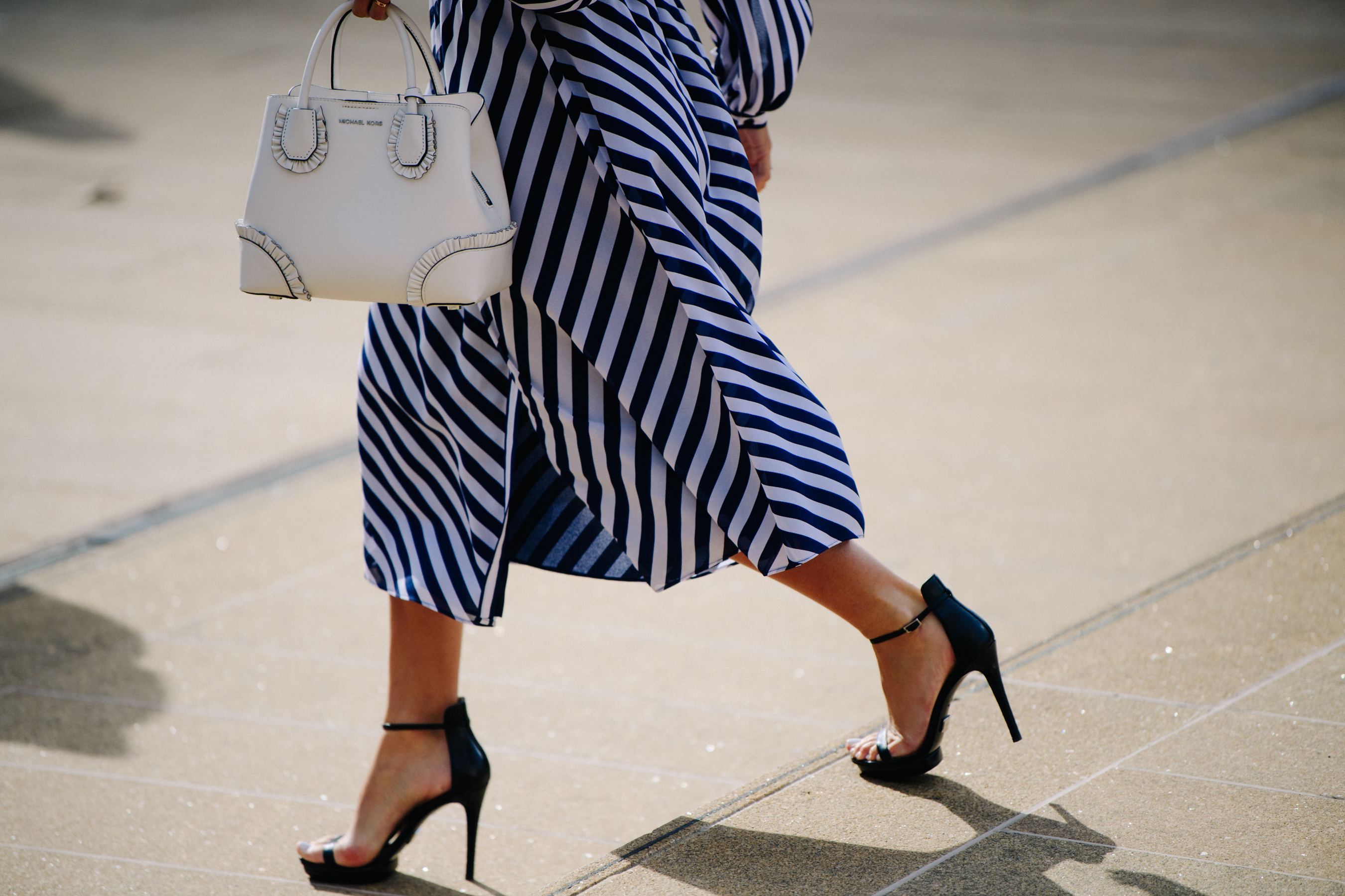 Woman wearing black and white striped dress