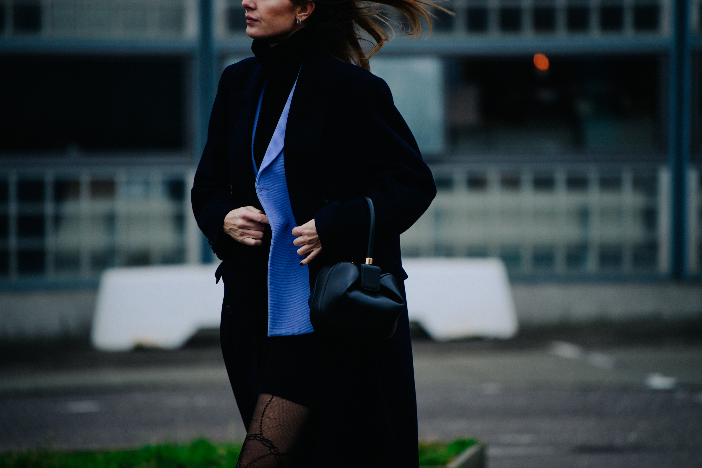 Woman holding black leather handbag