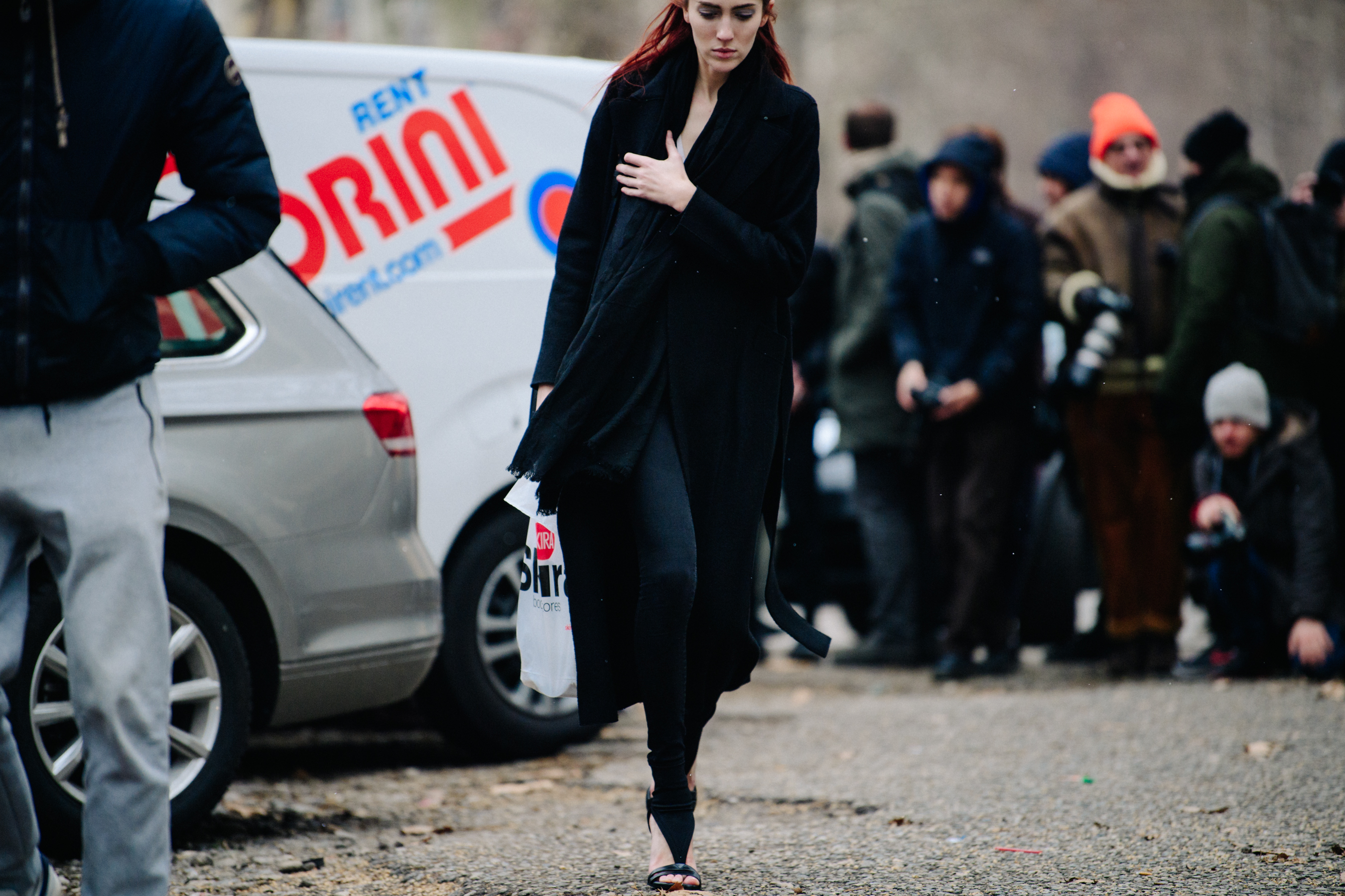 American model wearing long black coat