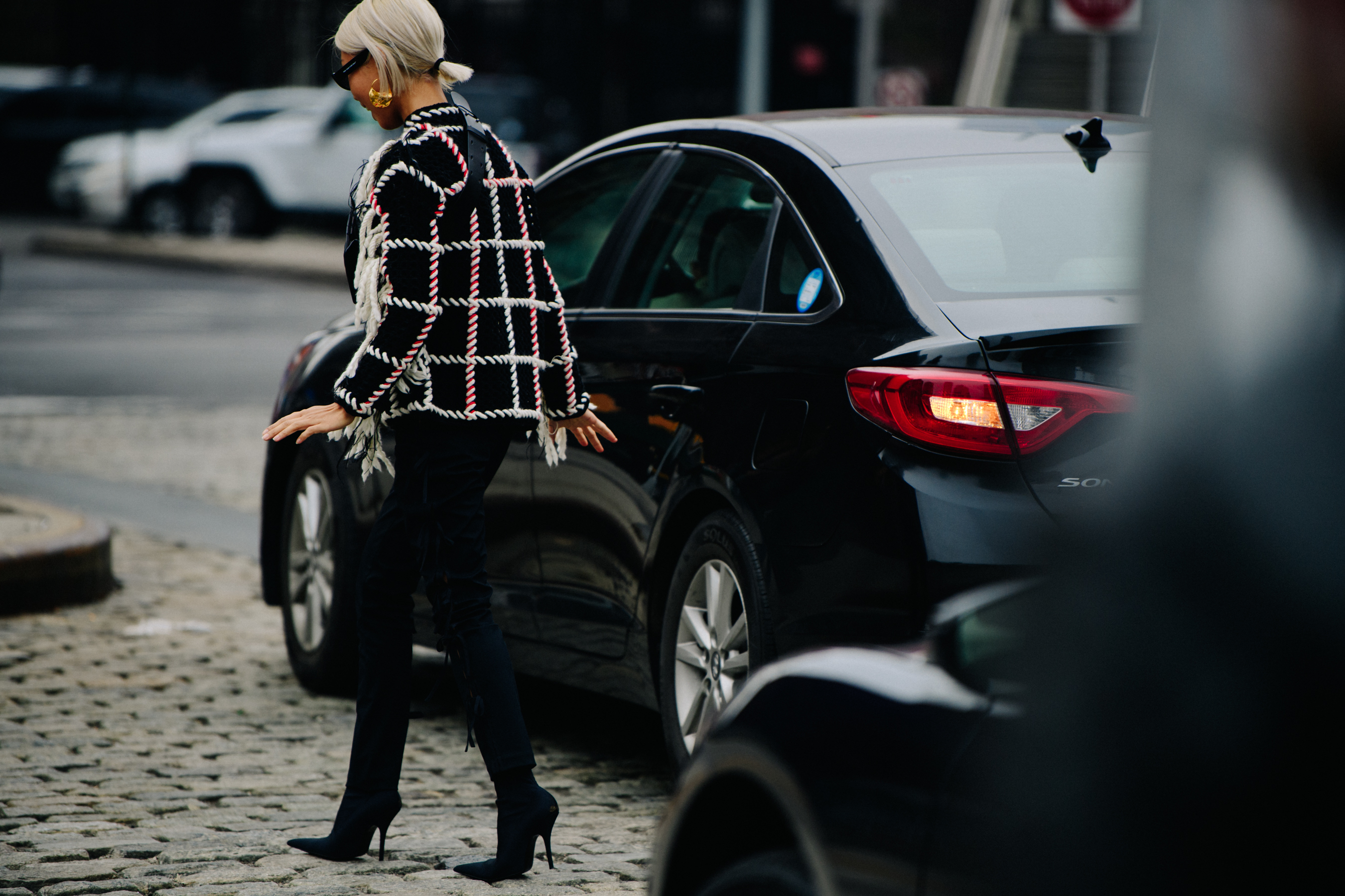 Woman wearing white and black check jacket