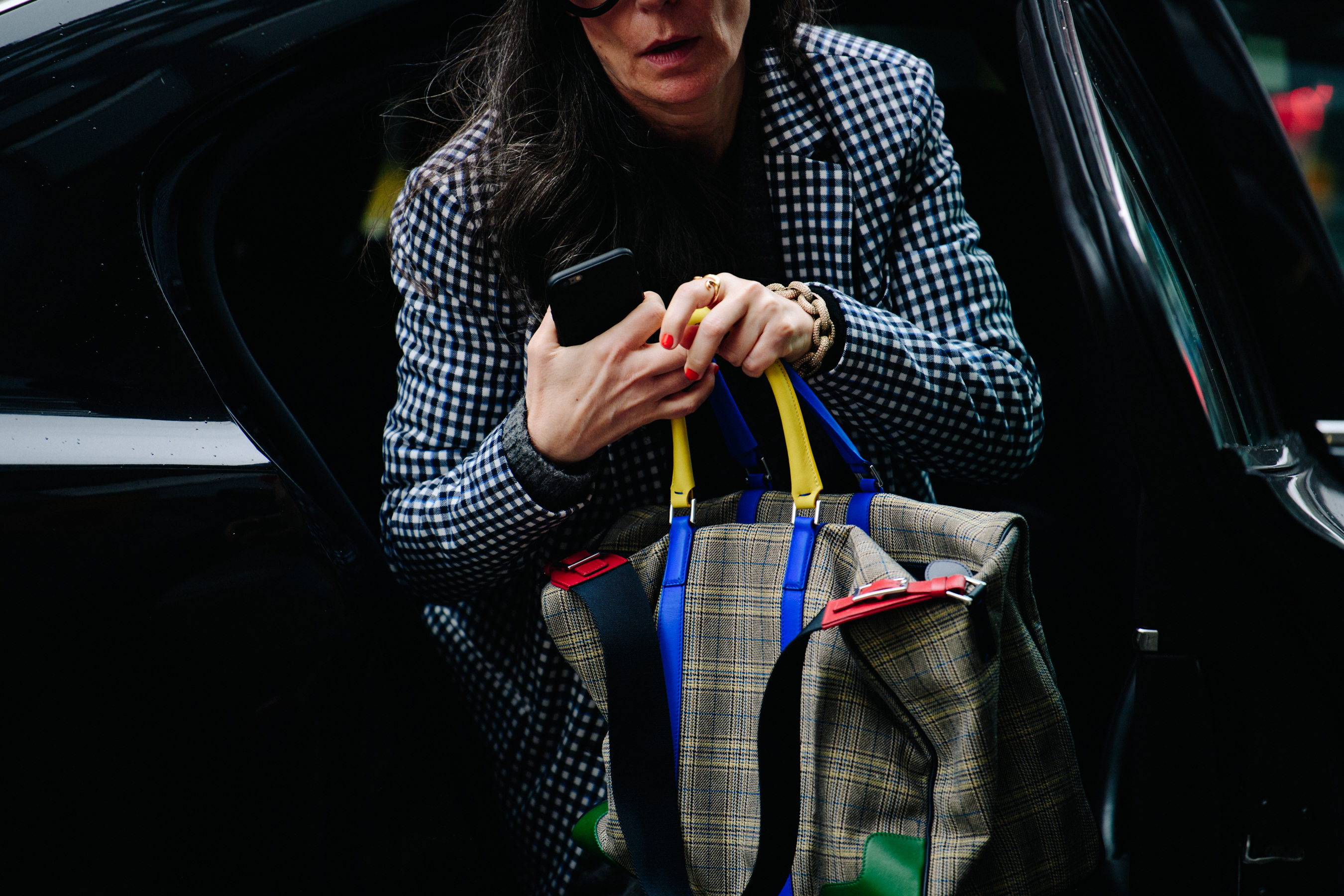 Woman carrying colourful strap bag