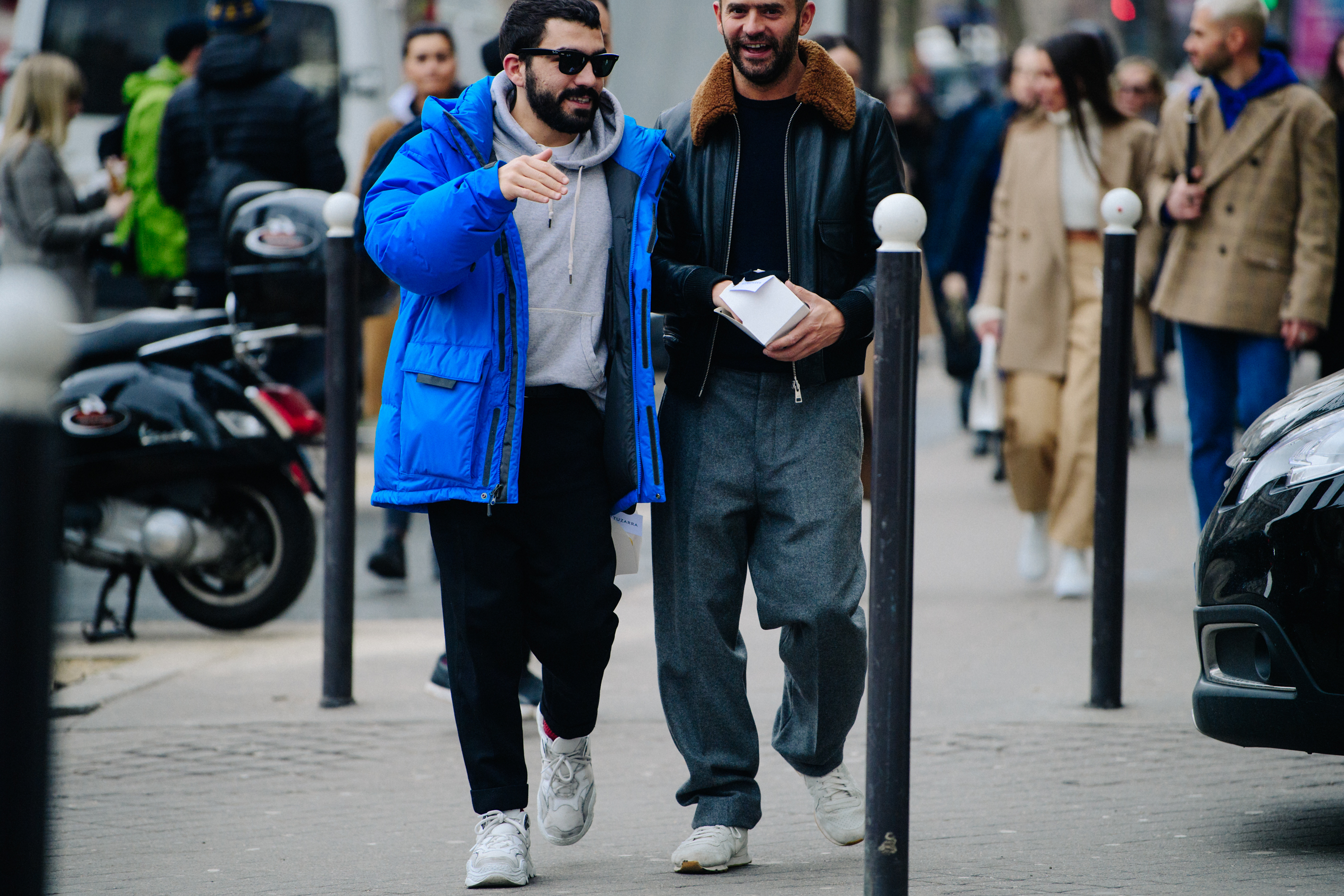 Two men wearing white sneakers