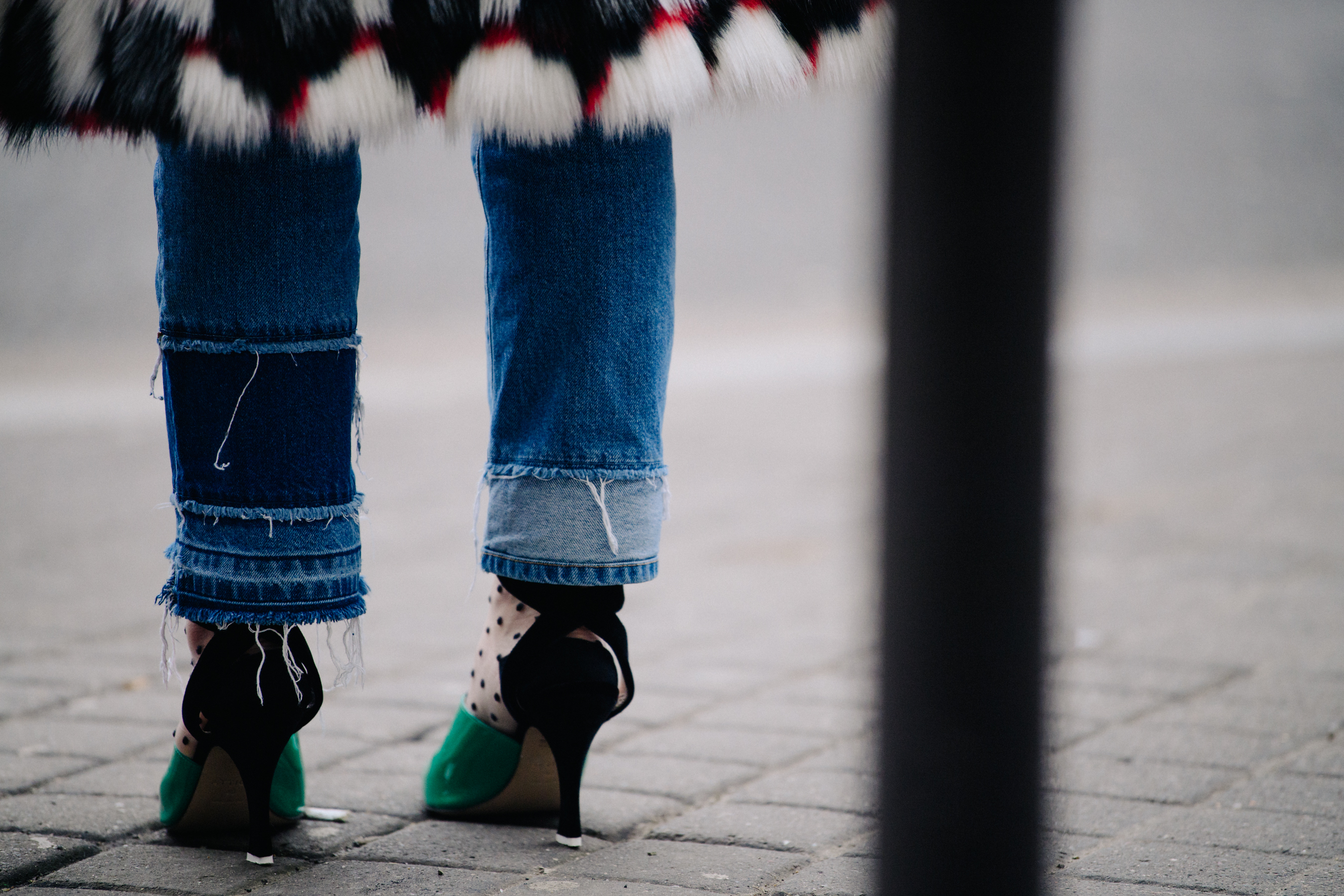 Woman wearing green and black heels