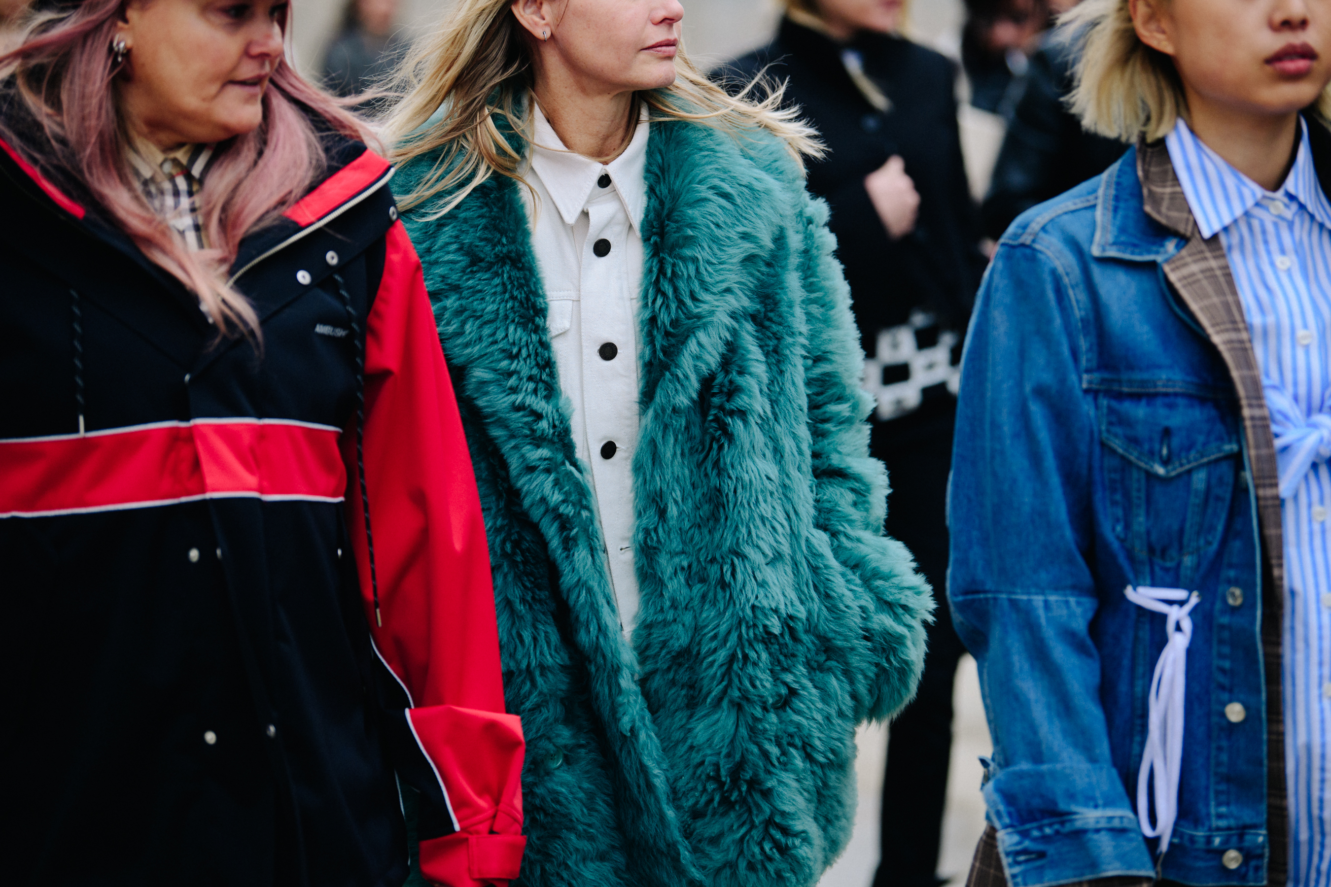 Three women wearing colourful jackets