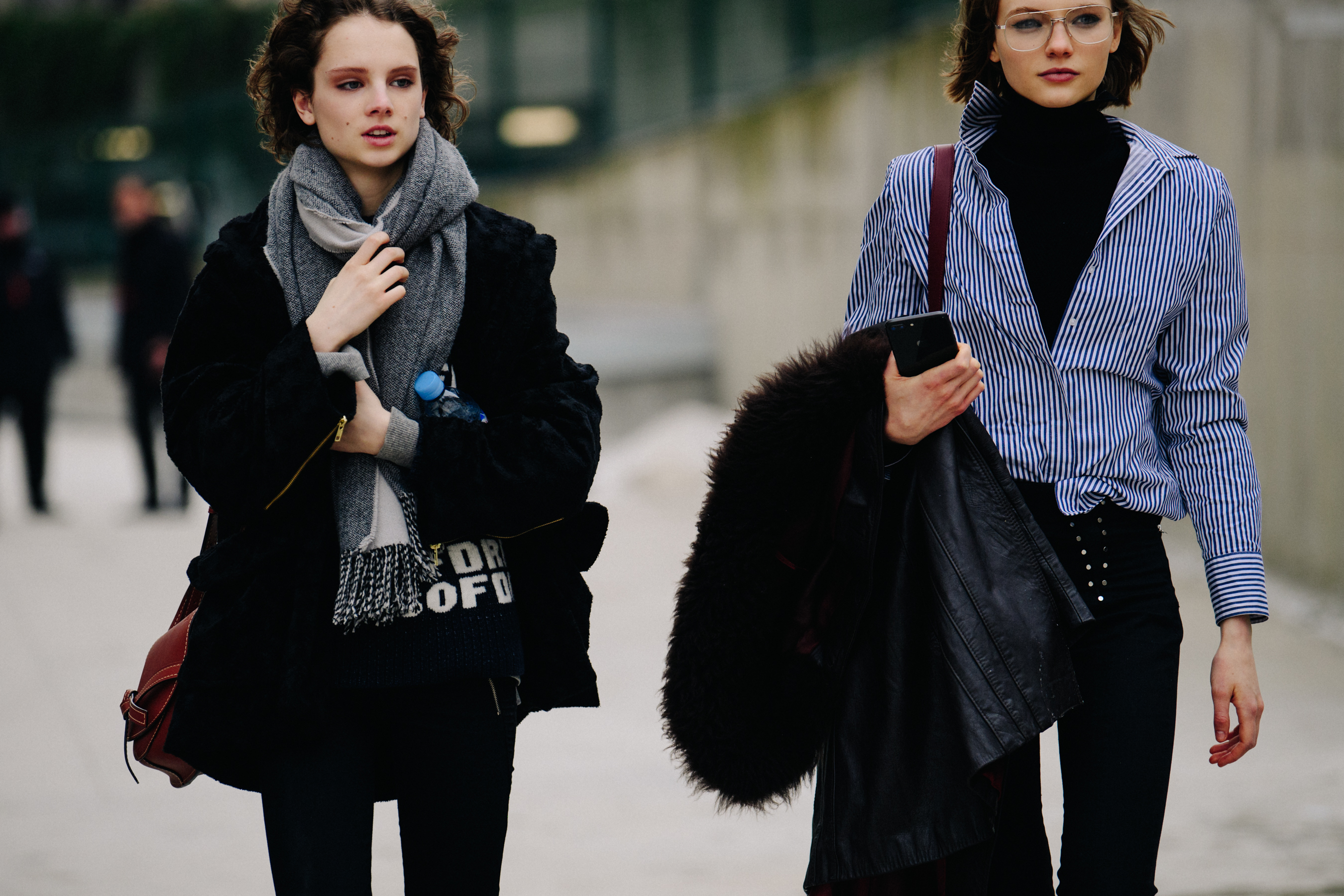 Two British models wearing black coats