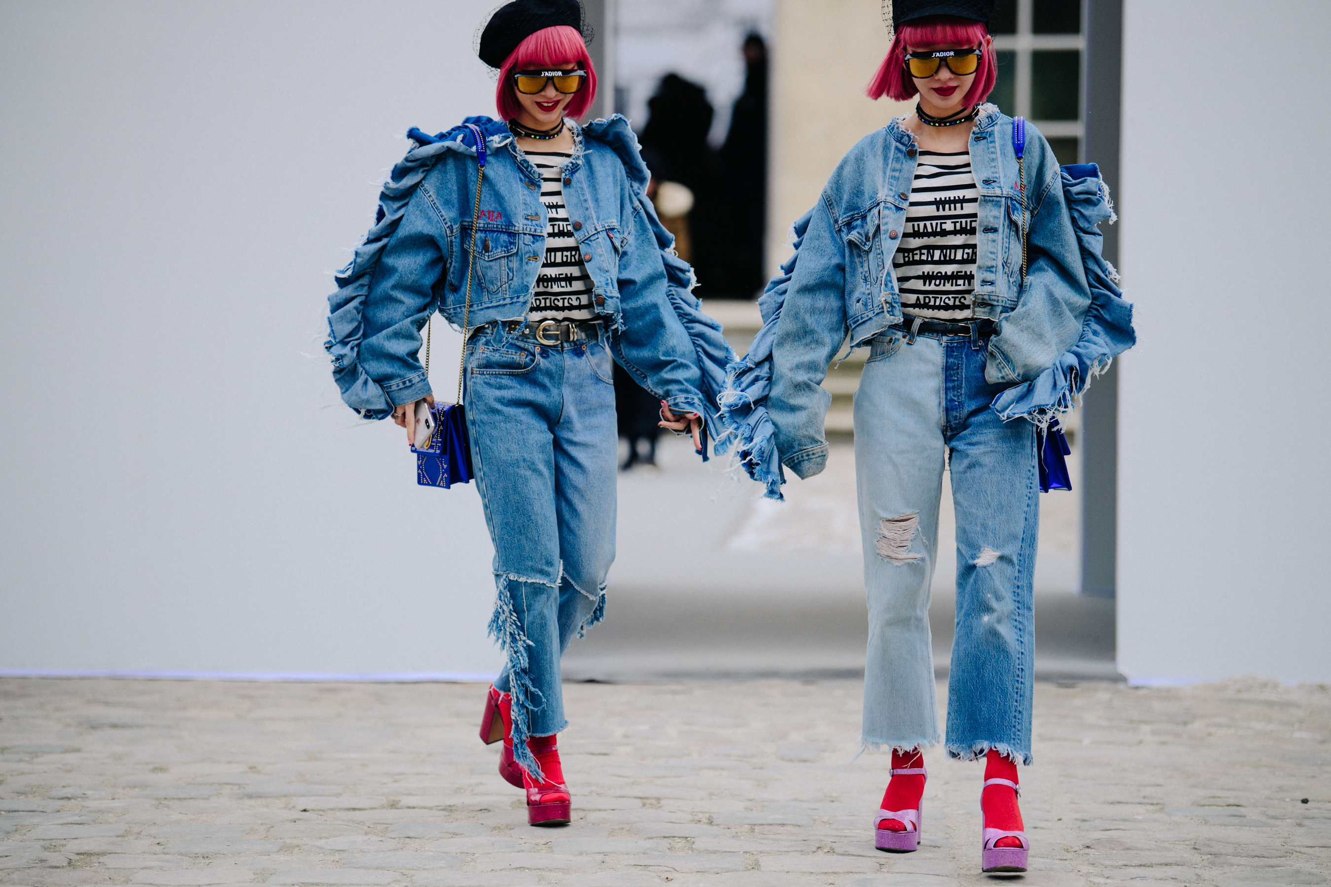 Two Asian women wearing denim Dior outfits