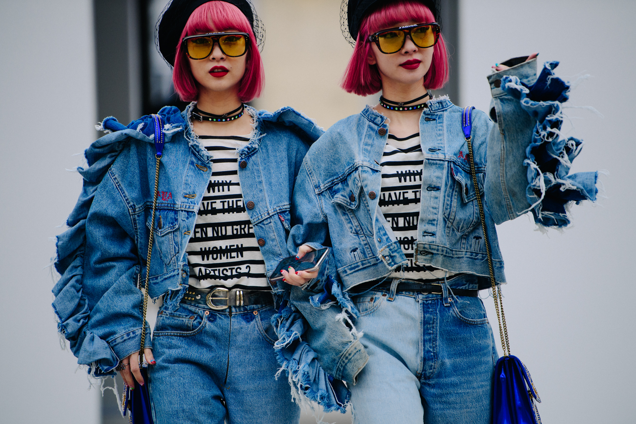 Two Asian women wearing denim Dior outfits