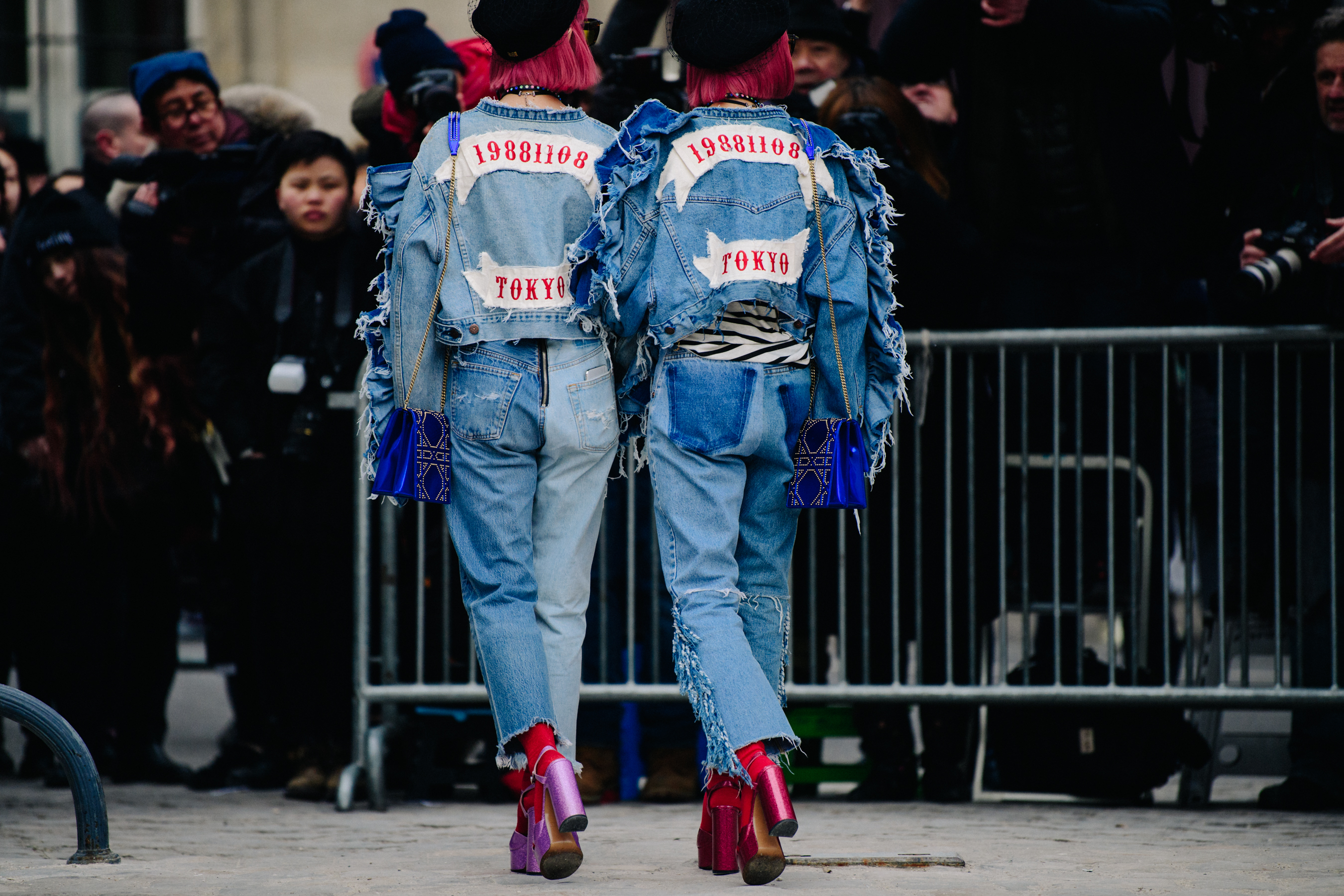 Two Asian women wearing denim Dior outfits