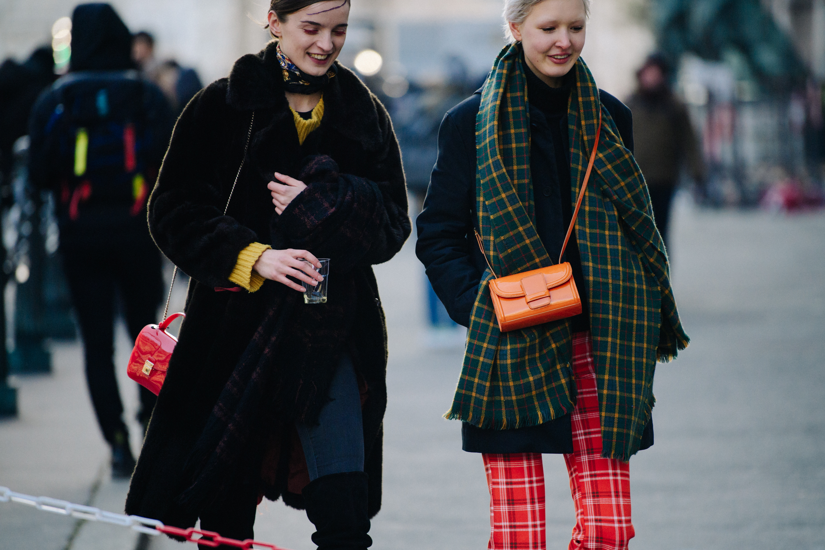Two models wearing long scarves