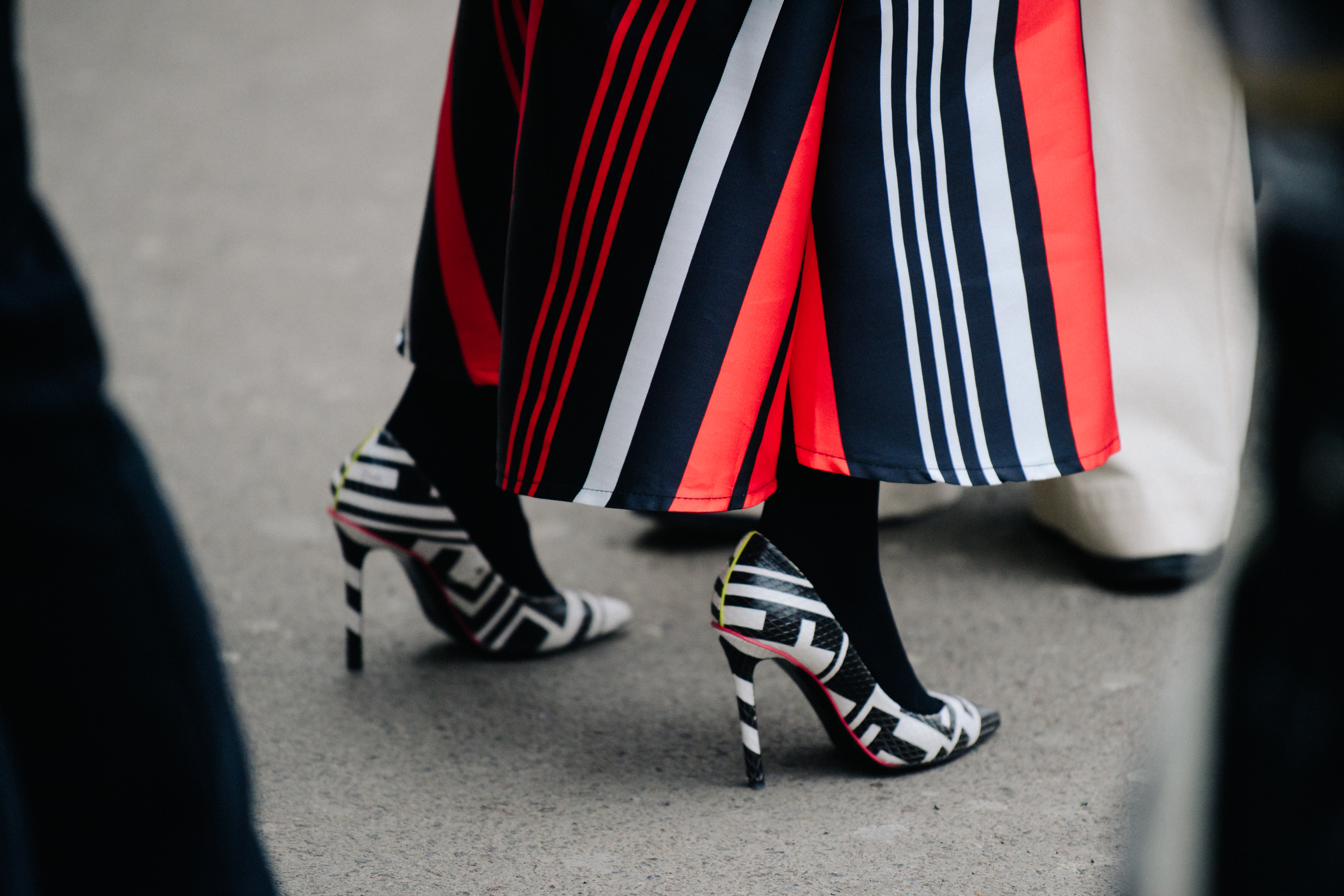 Woman wearing black and white heels