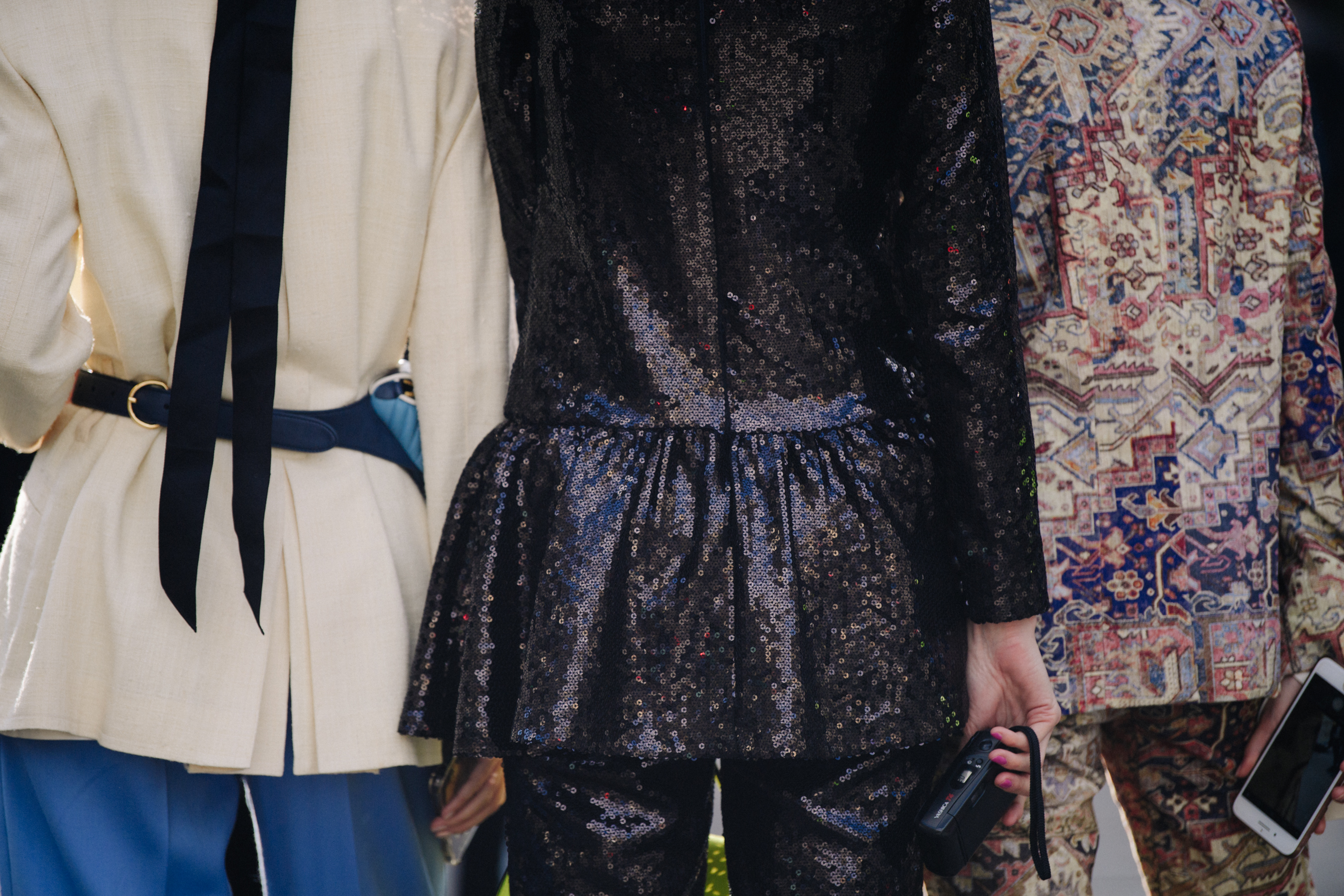 Three women wearing stylish jackets