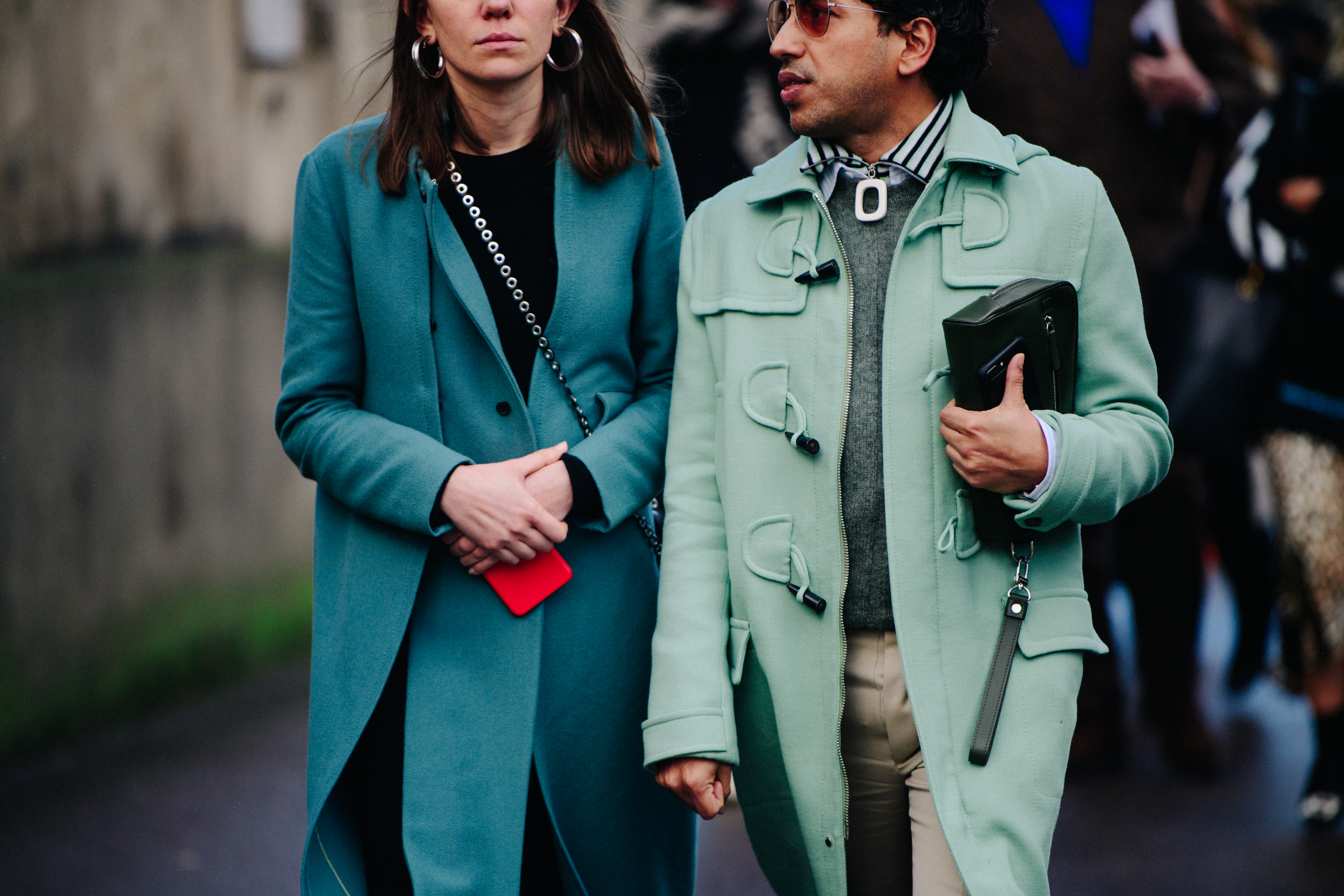 Couple wearing blue and green coats