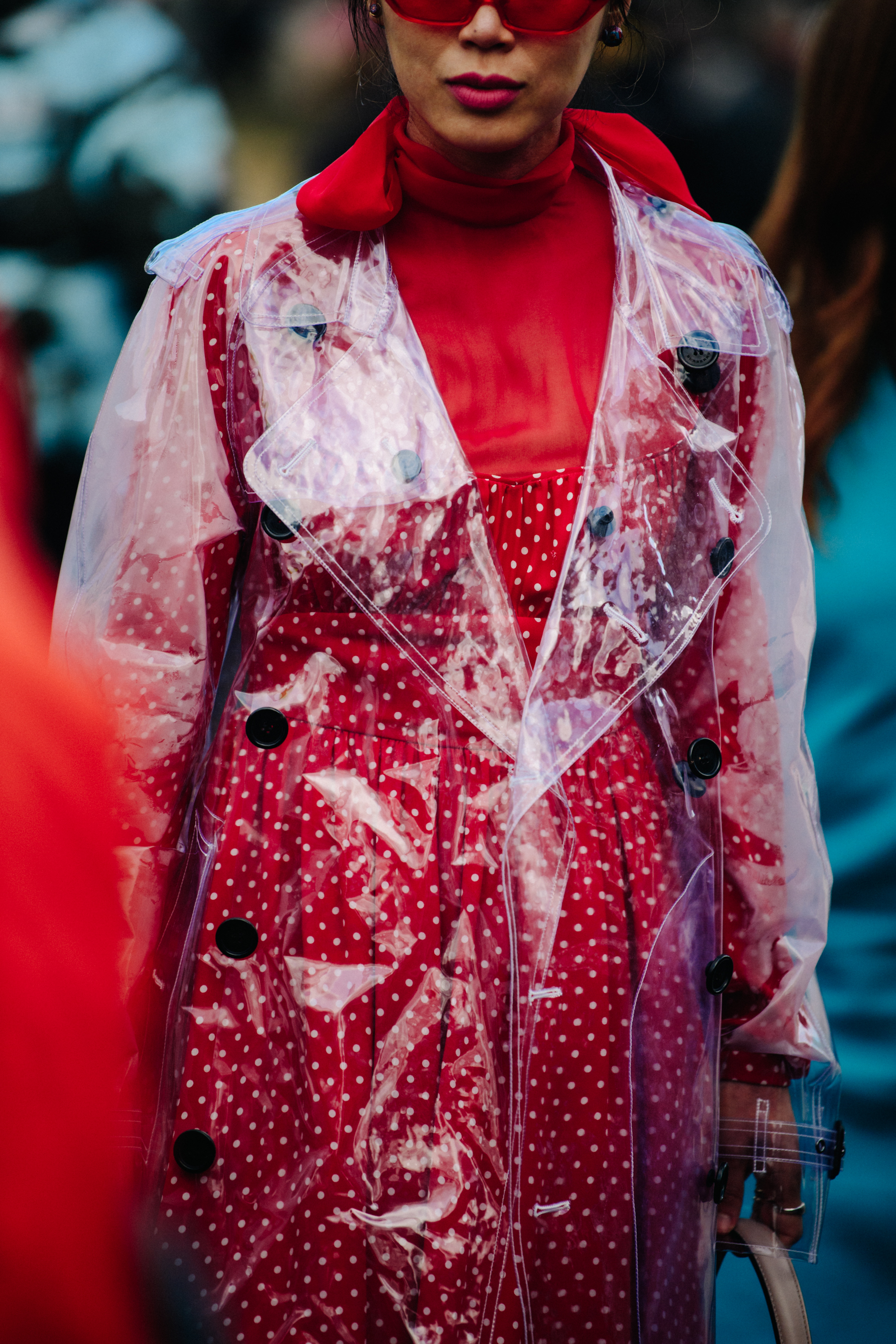 Asian blogger wearing plastic coat