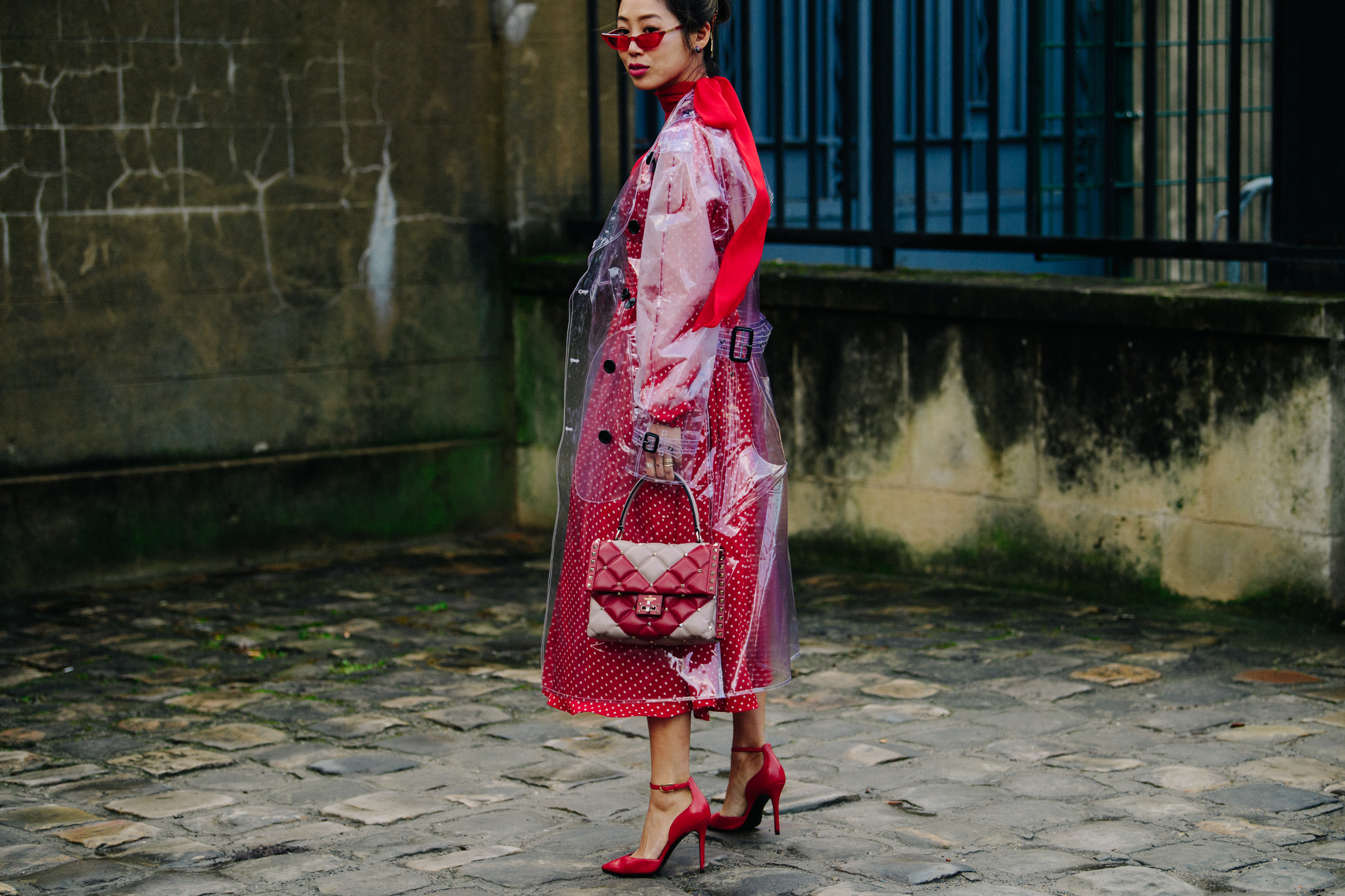 Asian blogger wearing plastic coat